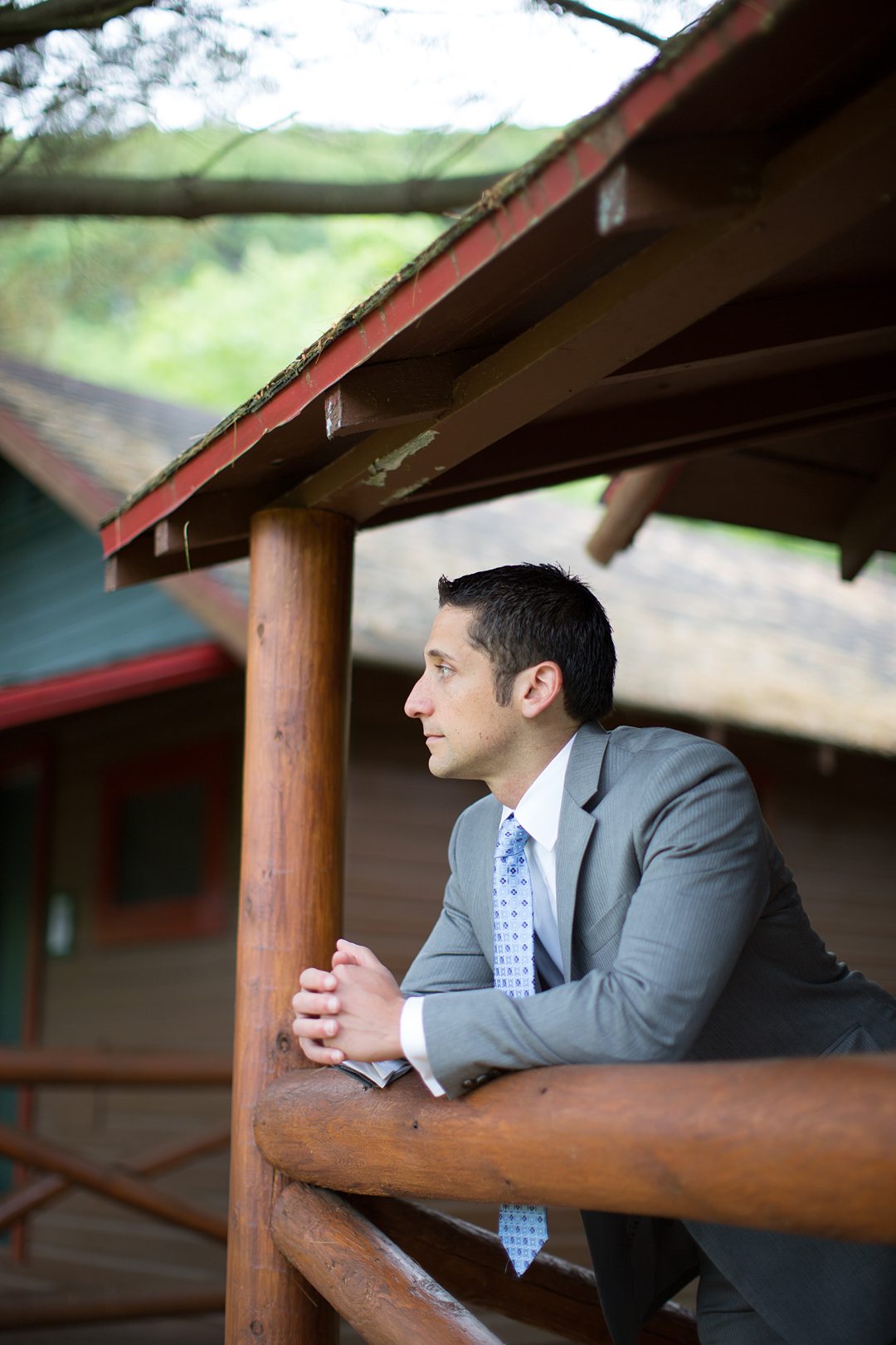 A grey suit and blue and purple tie was what the groom wore for wedding in the woods at Camp Getaway in Kent, CT. This summer camp venue is close to NYC. Photographed by Mikkel Paige Photography. 