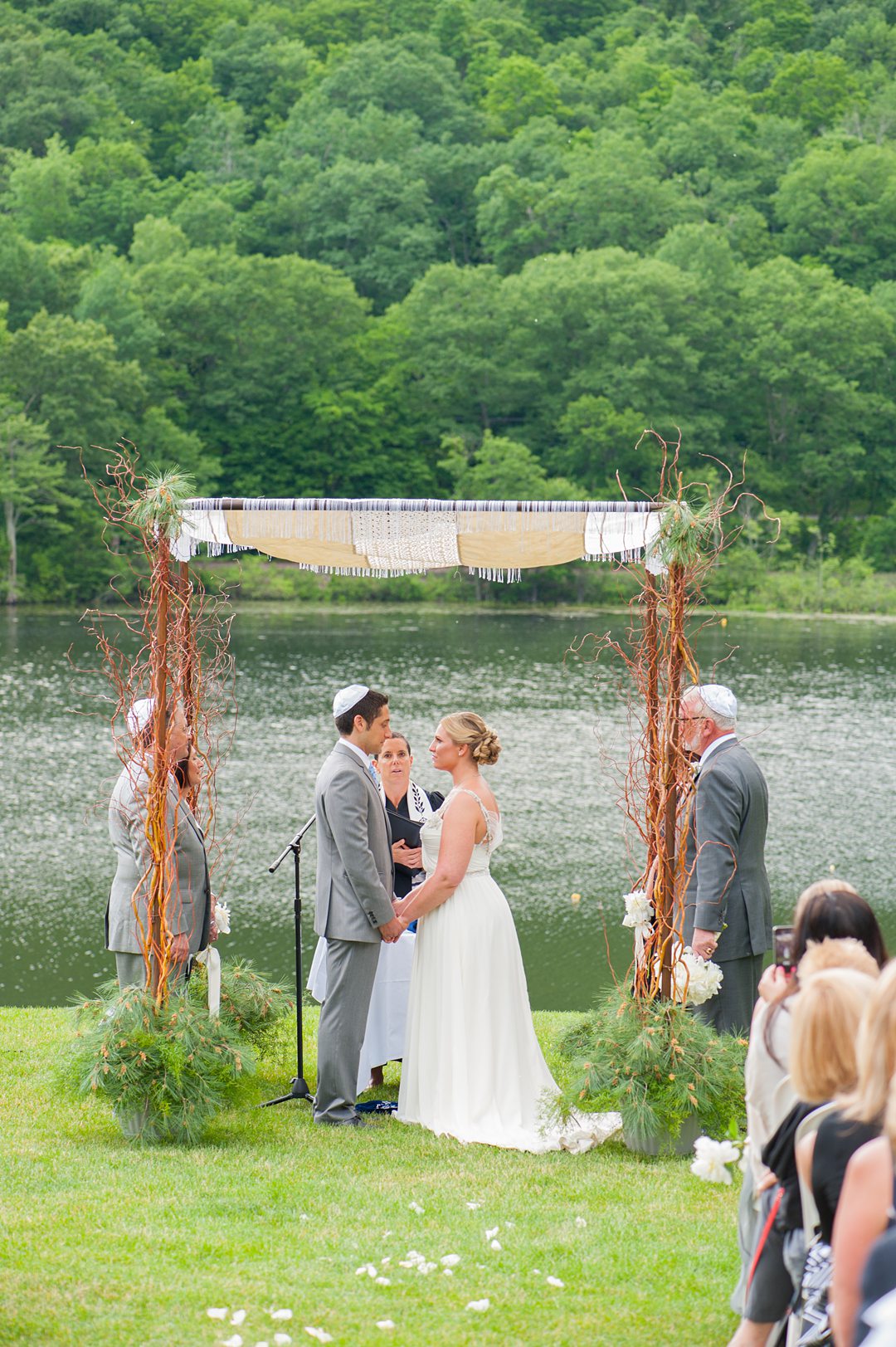 Ceremony photos by Mikkel Paige Photography overlooking the lake at Club Getaway. This sleepaway camp is the perfect venue for a fun wedding weekend.