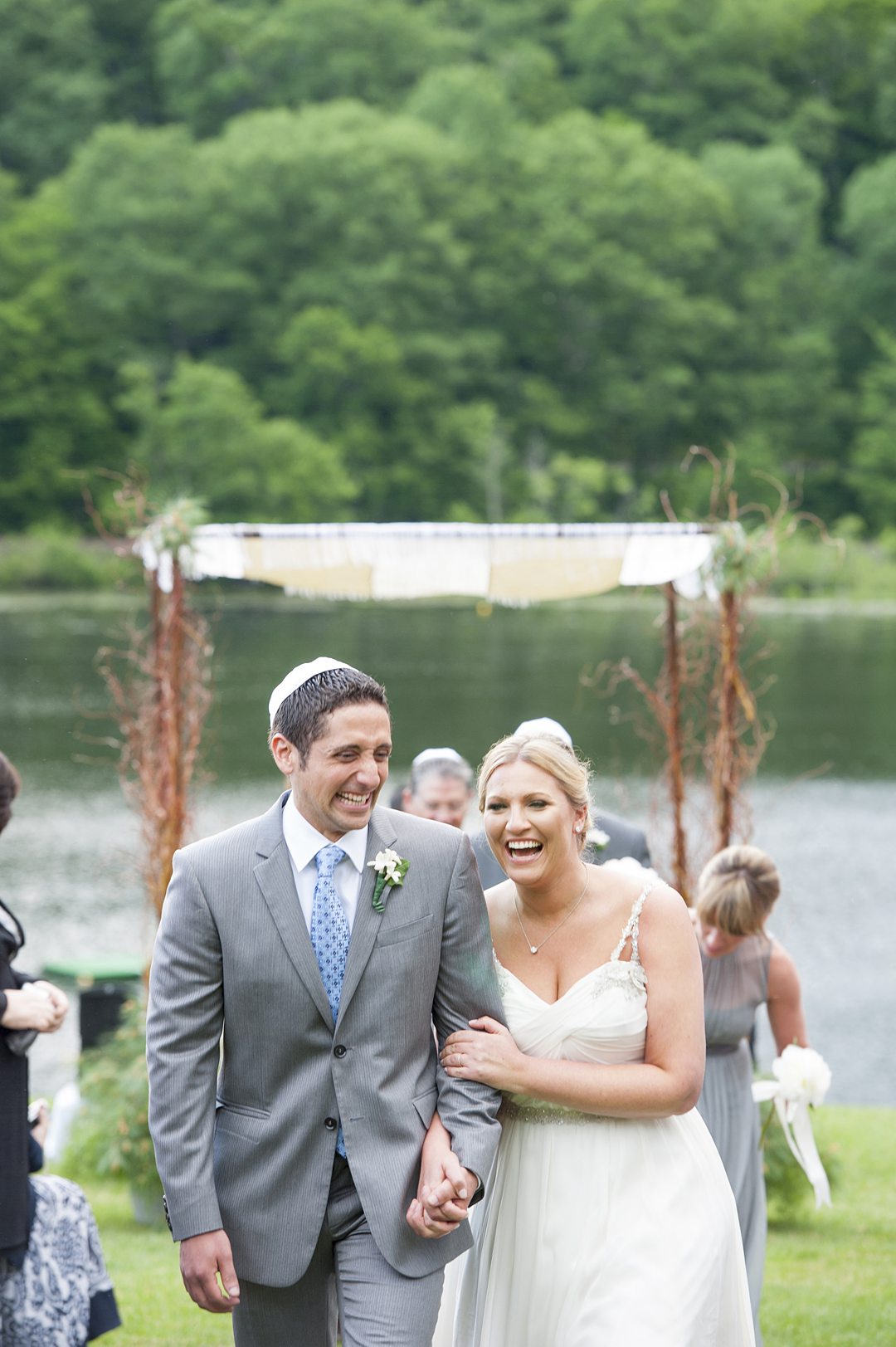 Ceremony photos by Mikkel Paige Photography overlooking the lake at Club Getaway. This sleepaway camp is the perfect venue for a fun wedding weekend.