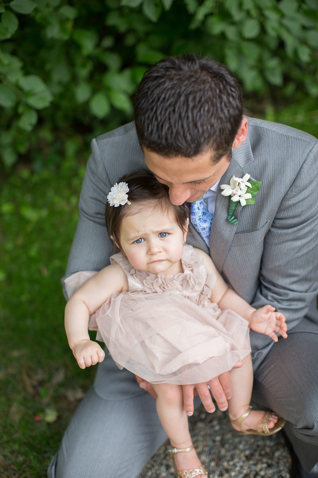 The groom and the flower girl at his destination wedding in Kent, Connecticut about 90 minutes from NYC. Photos by Mikkel Paige Photography.