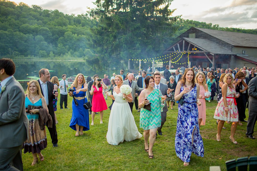 The band led a second line that had guests move from the cocktail hour to the dance floor and reception tent for a summer camp wedding photographed by Mikkel Paige Photography at Club Getaway.