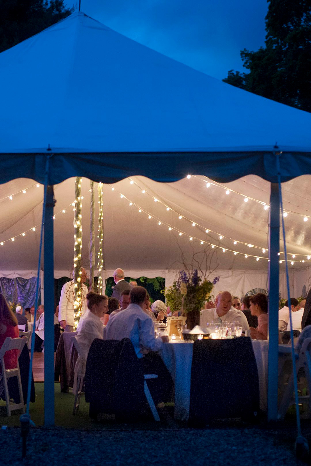 Dusk and the reception tent at Club Getaway. The summer camp wedding was photographed by Mikkel Paige Photography.