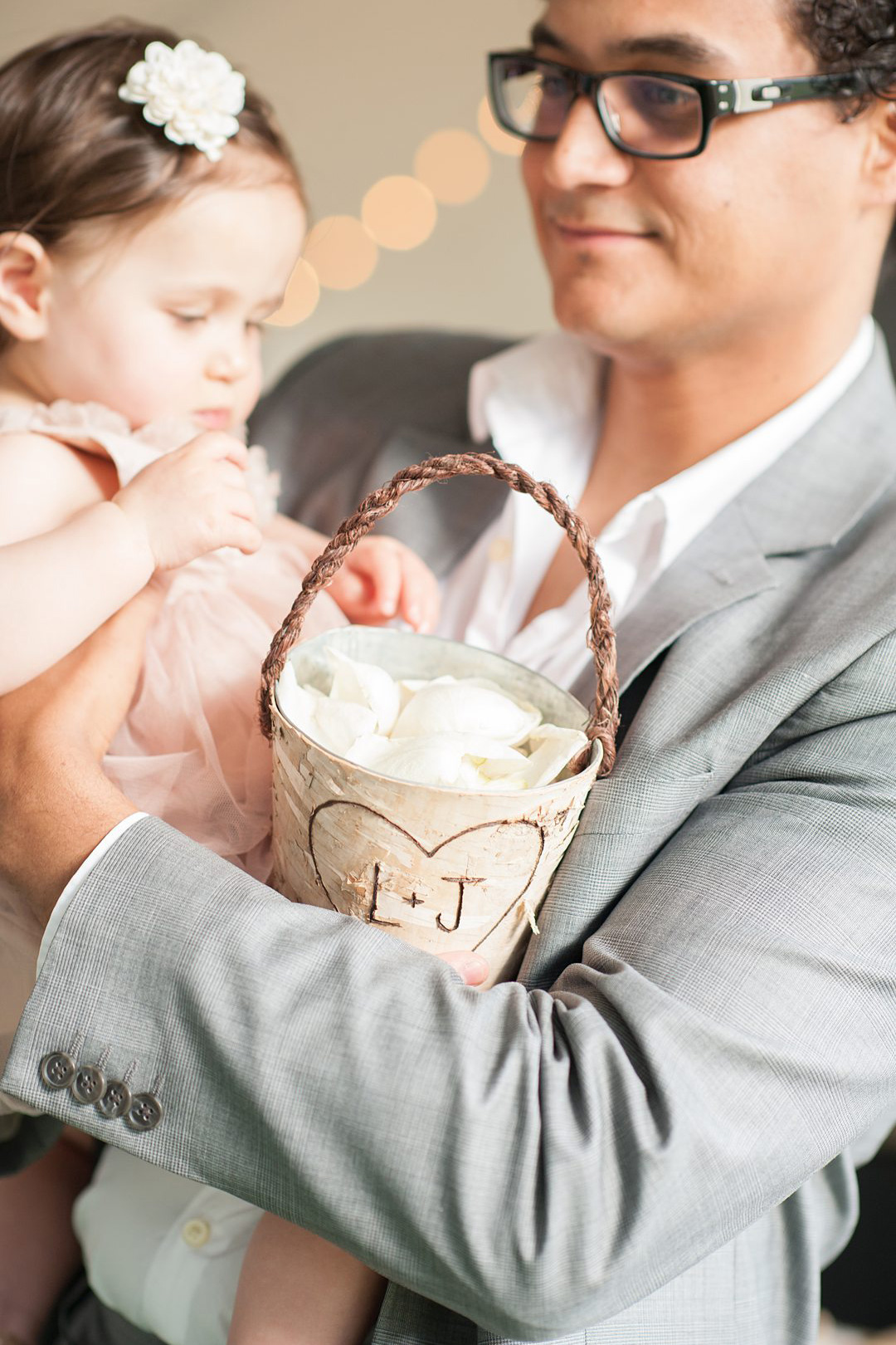 The flower girl petal bucket matched the bride and groom's woodsy cake for a wedding at sleepaway summer camp, Club Getaway. Photographed by Mikkel Paige Photography.