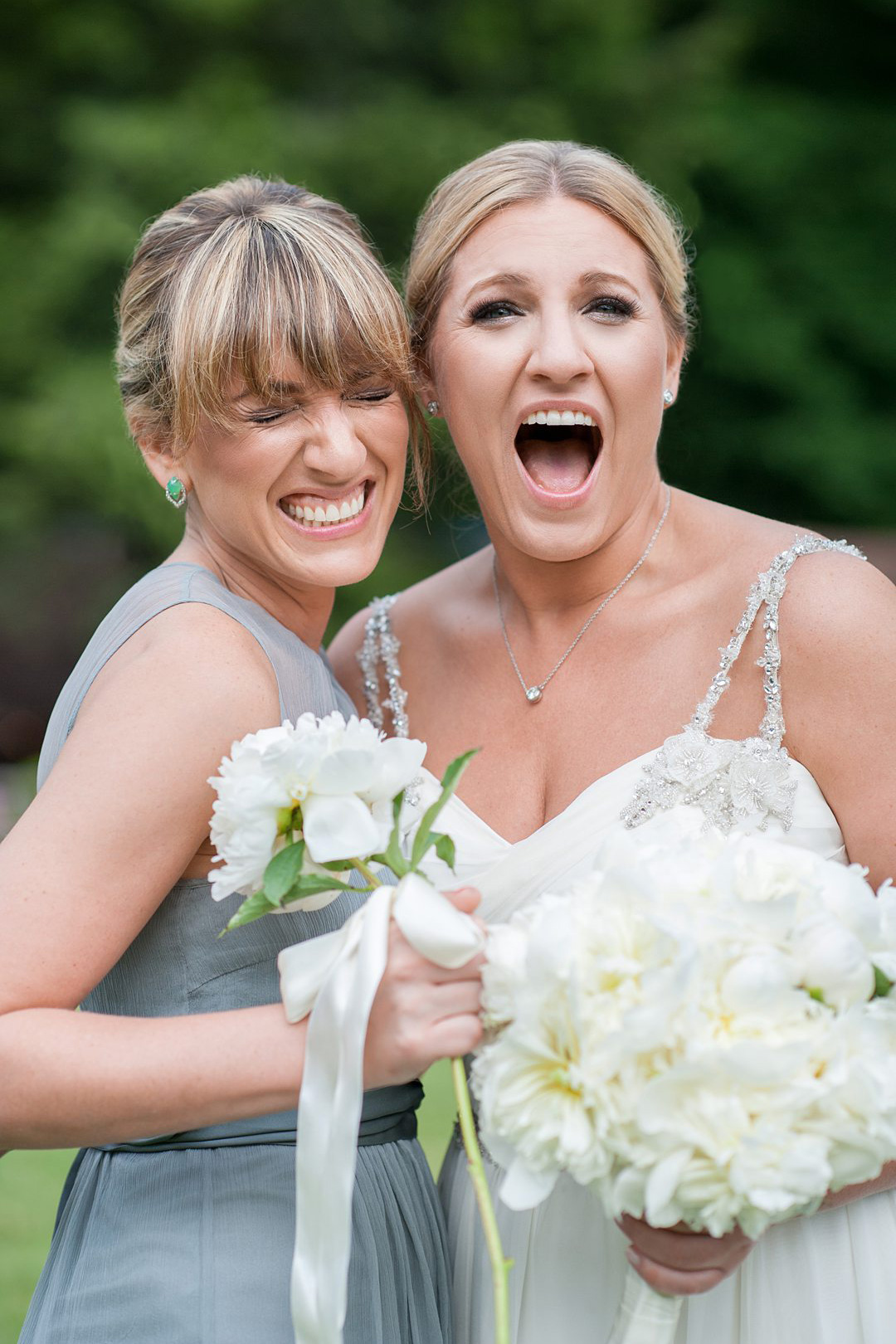 The bride and her sister, Maid of Honor, on her wedding day at Club Getaway, a summer camp wedding venue in the mountains. Photographed by Mikkel Paige Photography.