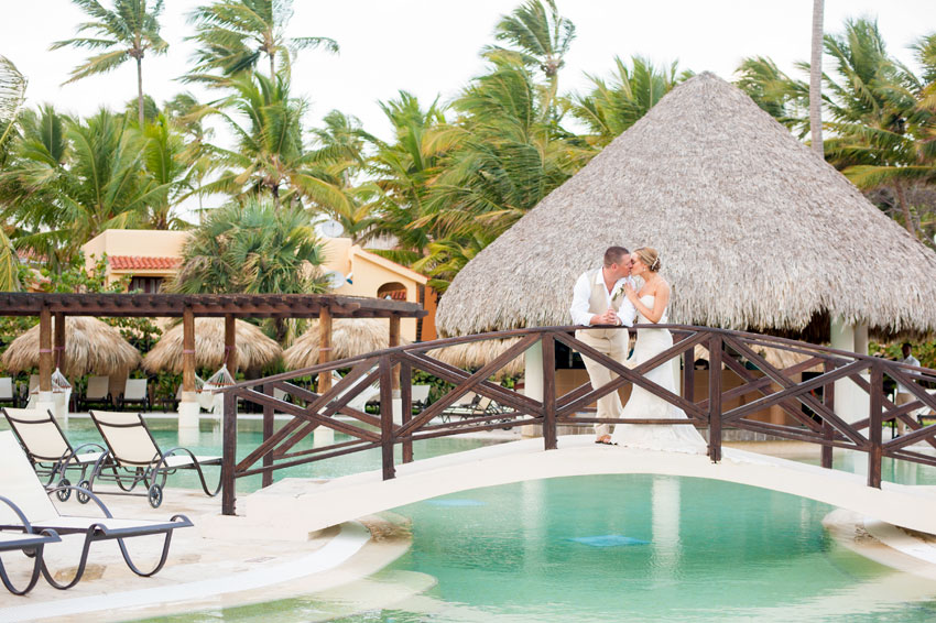 Caribbean Destination Wedding in Punta Cana, Dominican Republic at Larimar Resort. Photos by Mikkel Paige Photography. The bride and groom share a tropical moment.