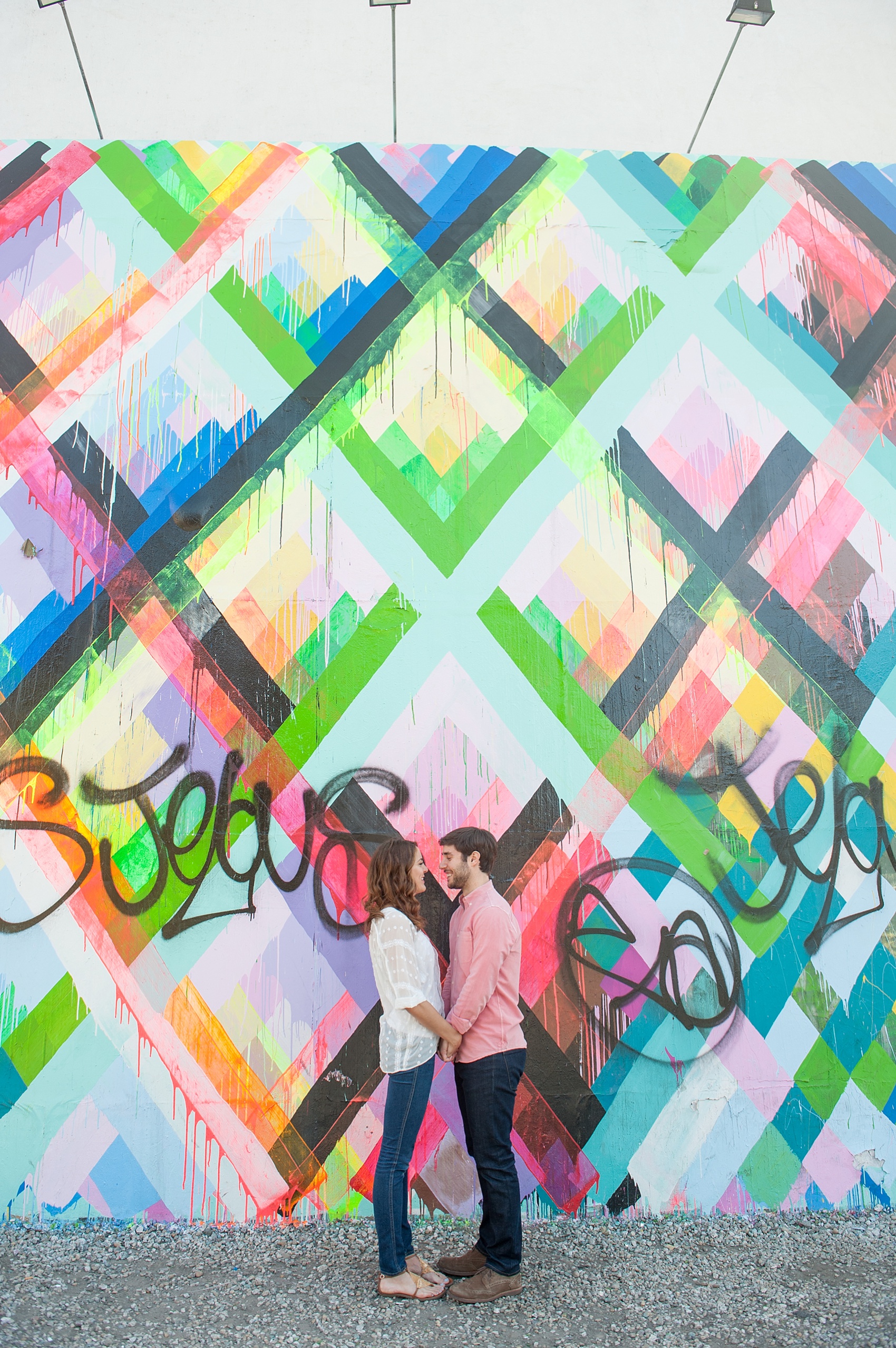 Couple's session at the Maya Hayuk geometric neon mural wall on Bowery Street in Manhattan. Photos by NYC wedding photographer, Mikkel Paige Photography.