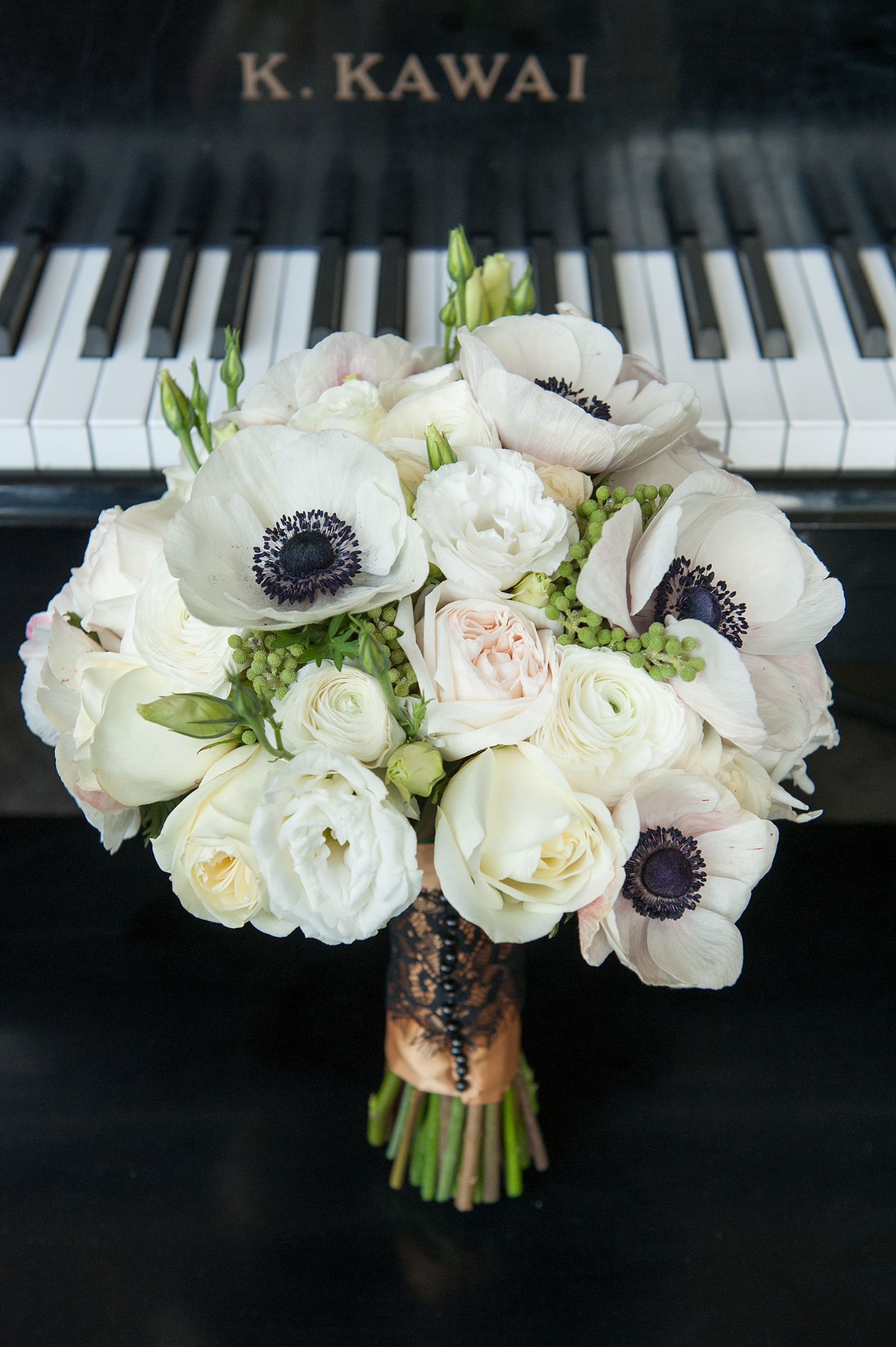 Floral bouquet of anemones and roses. Photos form a NYC Gold and Black wedding inspiration photo shoot by Mikkel Paige Photography.