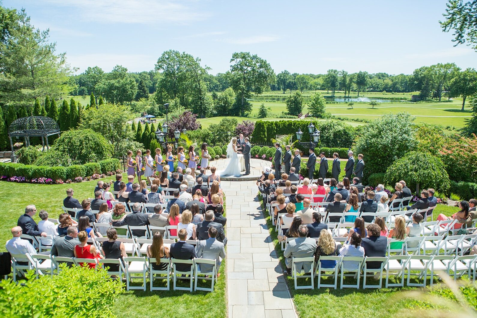 Outdoor summer wedding ceremony at The Park Savoy in New Jersey. Photo by Mikkel Paige Photography.