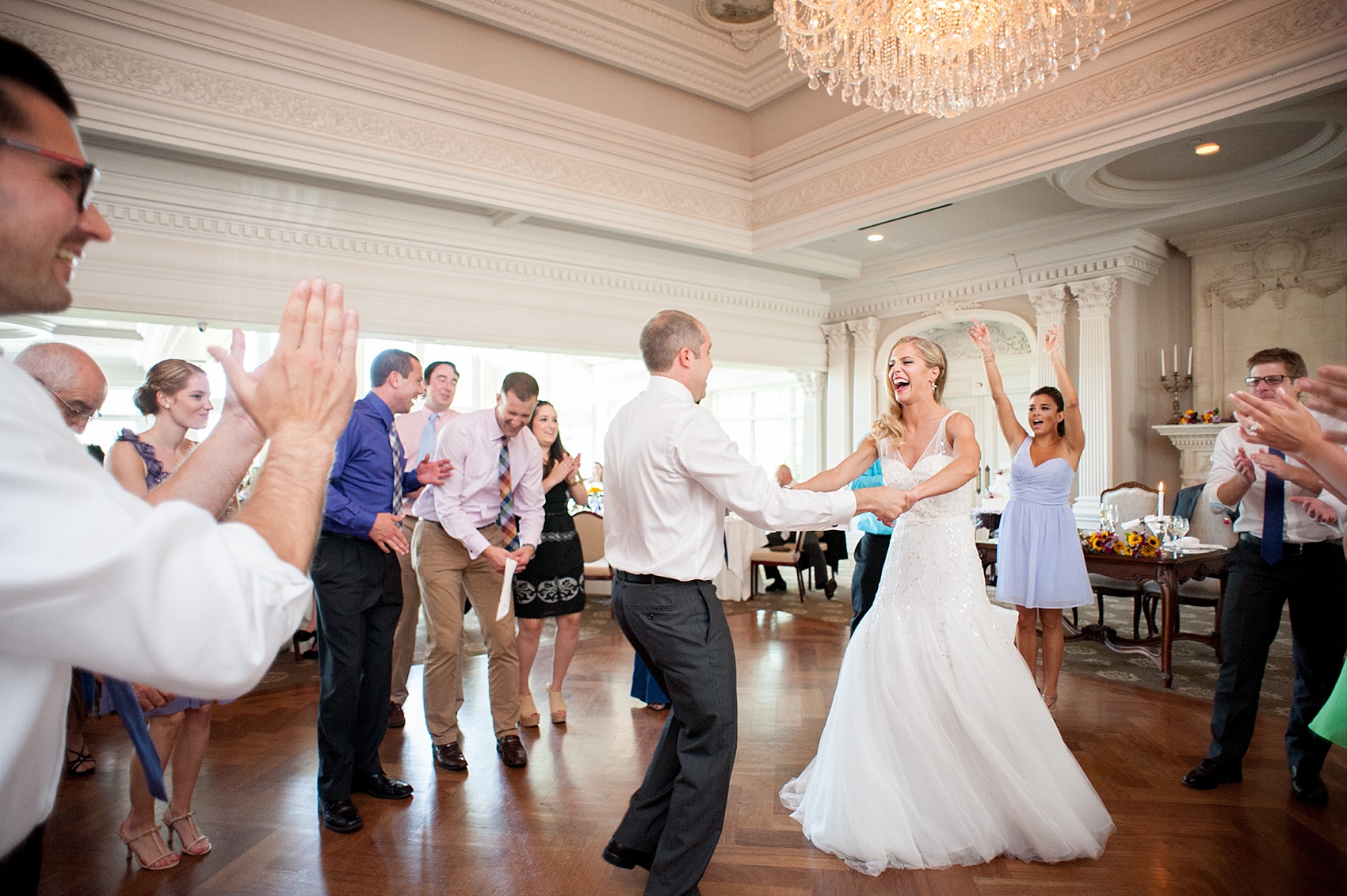 The bride and groom enjoy a spin on the dance floor at their daytime summer wedding. Photo by Mikkel Paige Photography. 