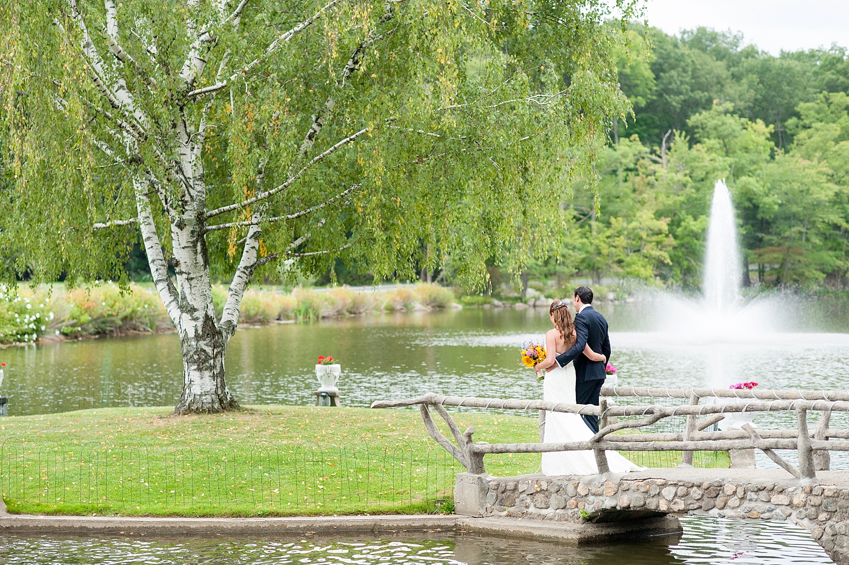 Perona Farms wedding photos bride and groom on the bridge colorful summer celebration. Pictures by New Jersey photographer Mikkel Paige Photography.
