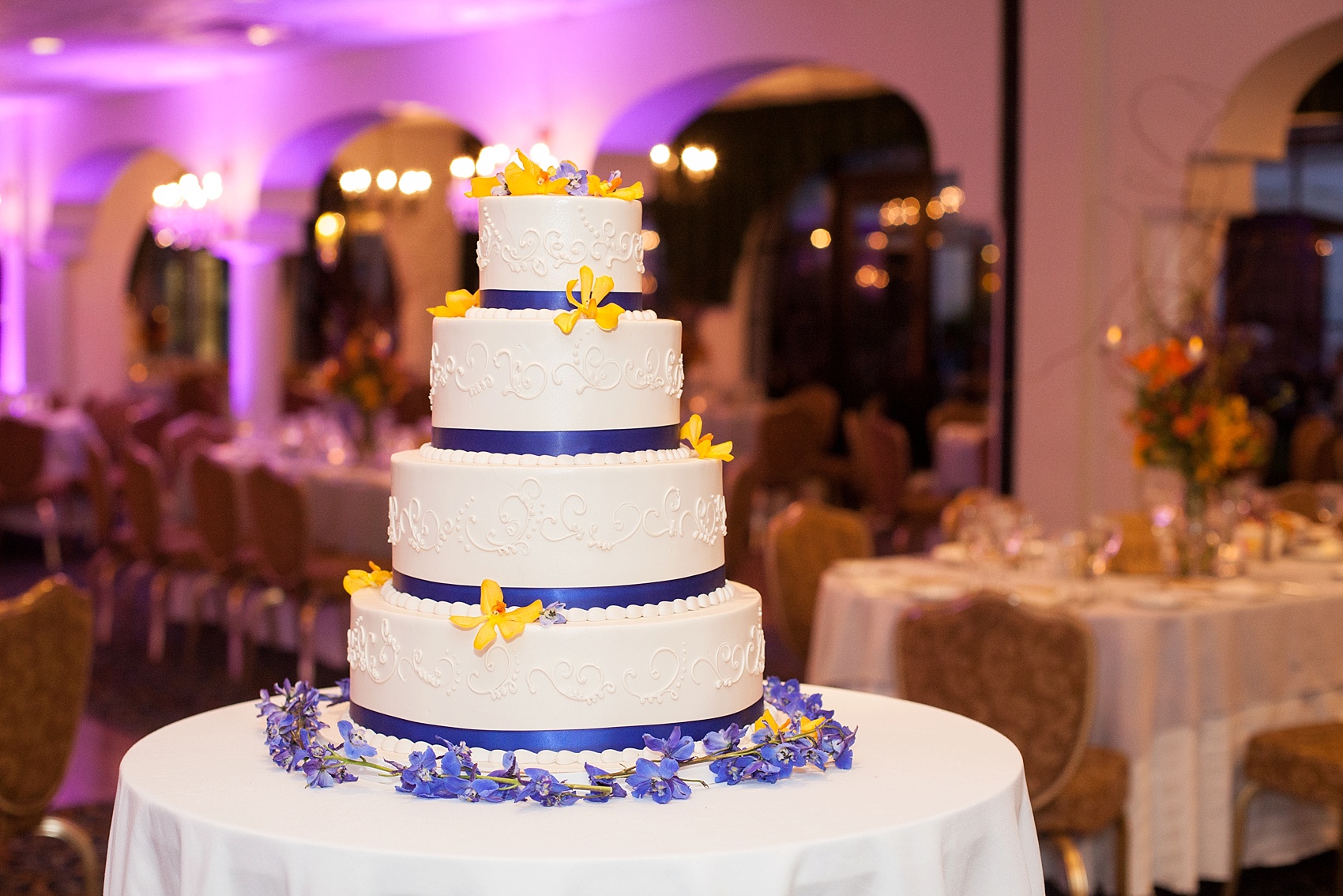 Perona Farms wedding photos tiered purple, yellow and white buttercream cake for a colorful summer celebration. Pictures by New Jersey photographer Mikkel Paige Photography.