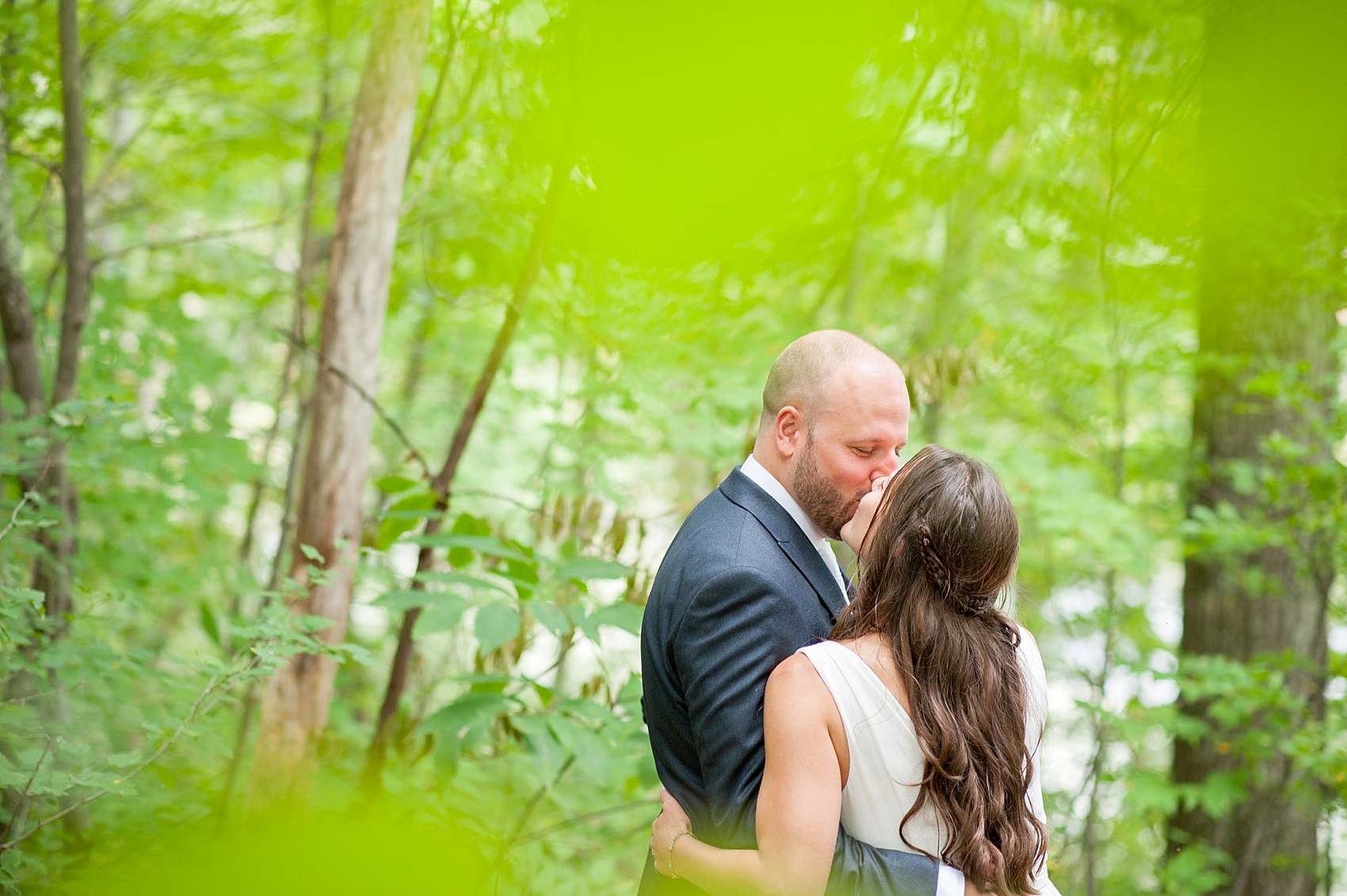 Bride and groom forest photos at their rustic Massachusetts Berkshires wedding at Camp Wa Wa Segowea. Photos by Mikkel Paige Photography, destination wedding photographer.