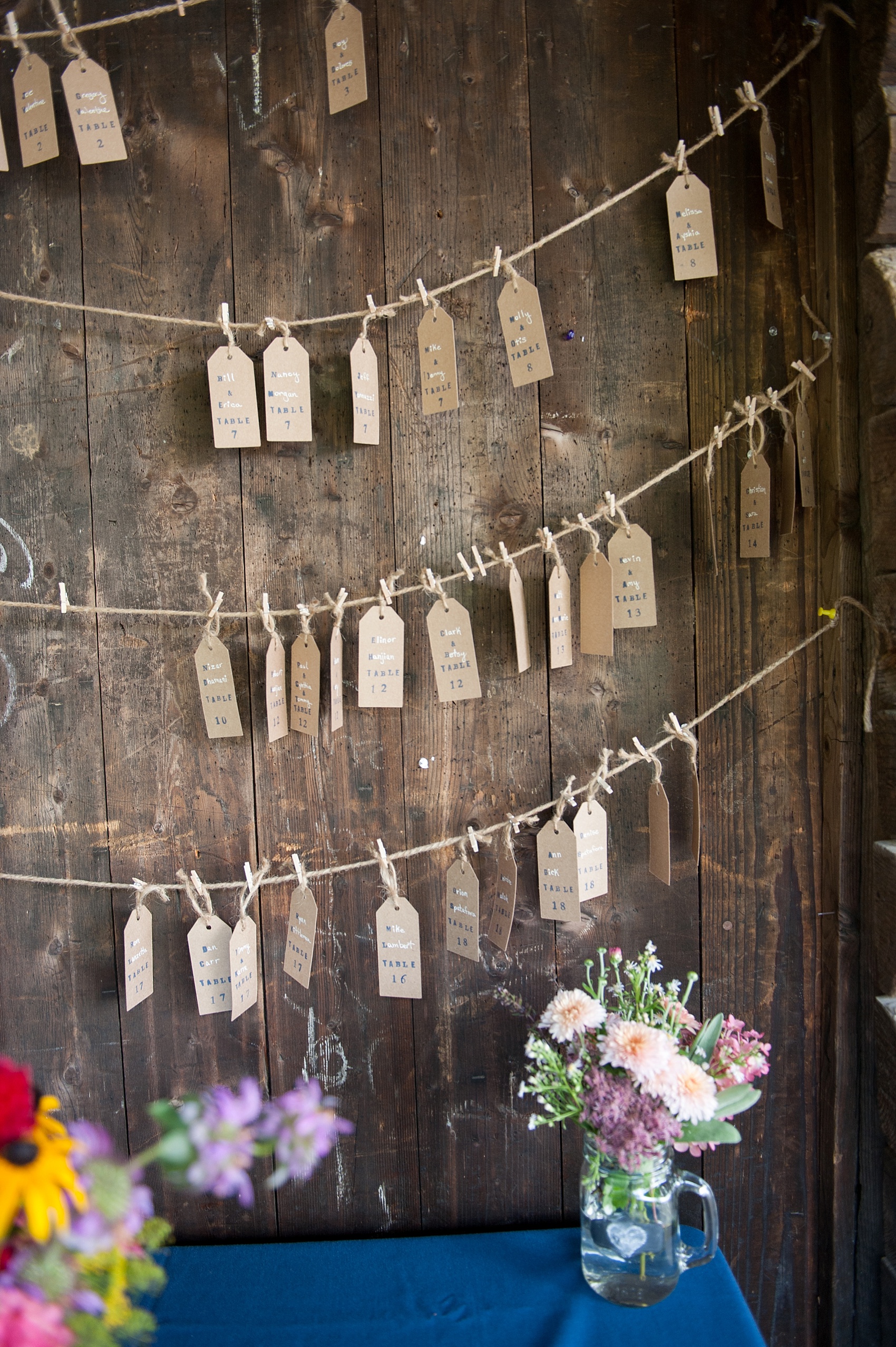 Rustic Berkshires camp wedding escort tags on a clothesline of twine. Photos by Massachusetts wedding photographer, Mikkel Paige Photography.