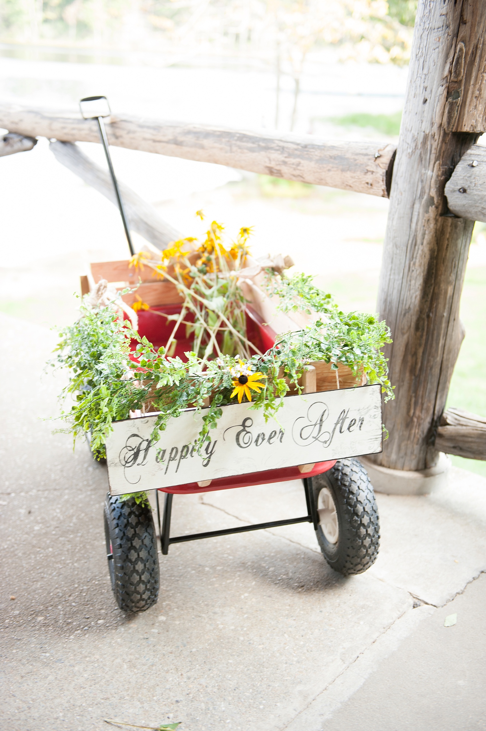 Red wagon with "Happily Ever After" sign for a rustic Berkshires camp wedding. Photos by Massachusetts wedding photographer, Mikkel Paige Photography.