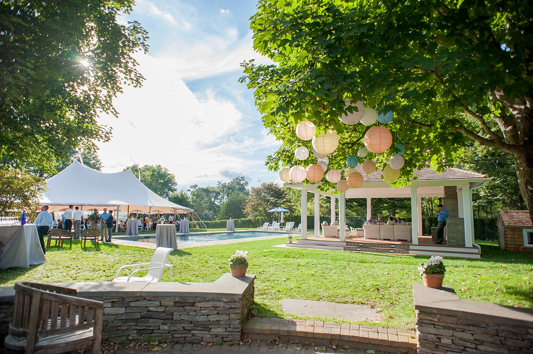 Hanging lanterns and tented outdoor same sex Hamptons wedding. Photos by NYC photographer, Mikkel Paige Photography.