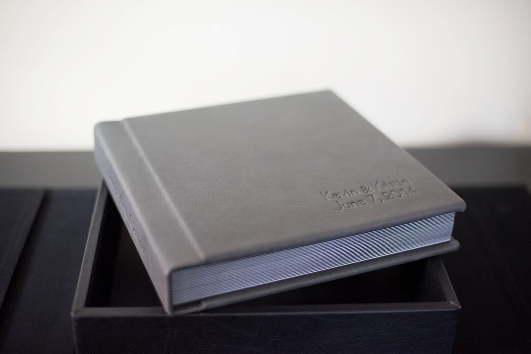 Grey leather wedding album with debossing on cover and spine, by Mikkel Paige Photography.