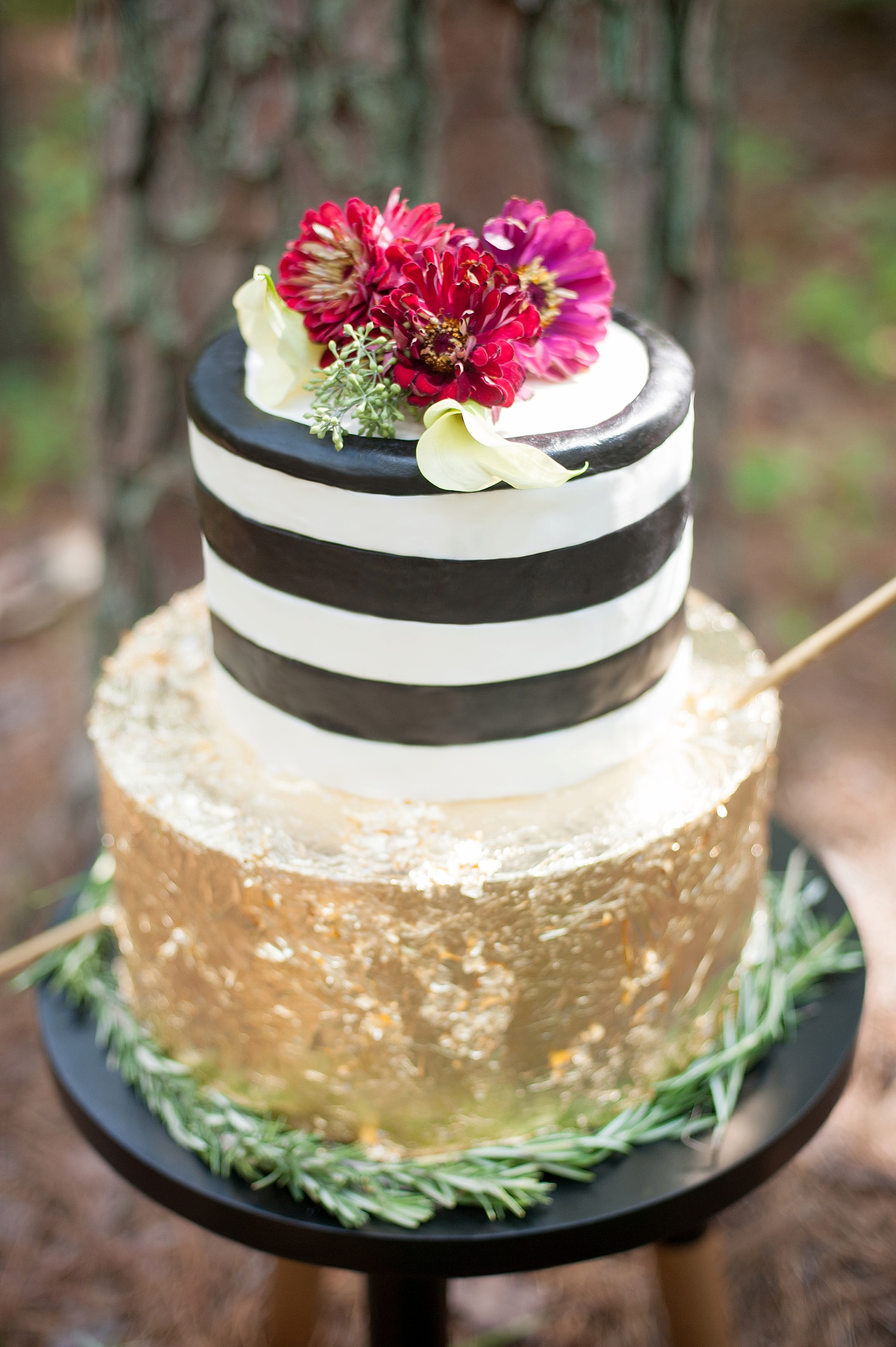 Raleigh, NC wedding inspiration by Mikkel Paige Photography. Modern faux deer head and striped black, white and gold cake at Umstead Park. 