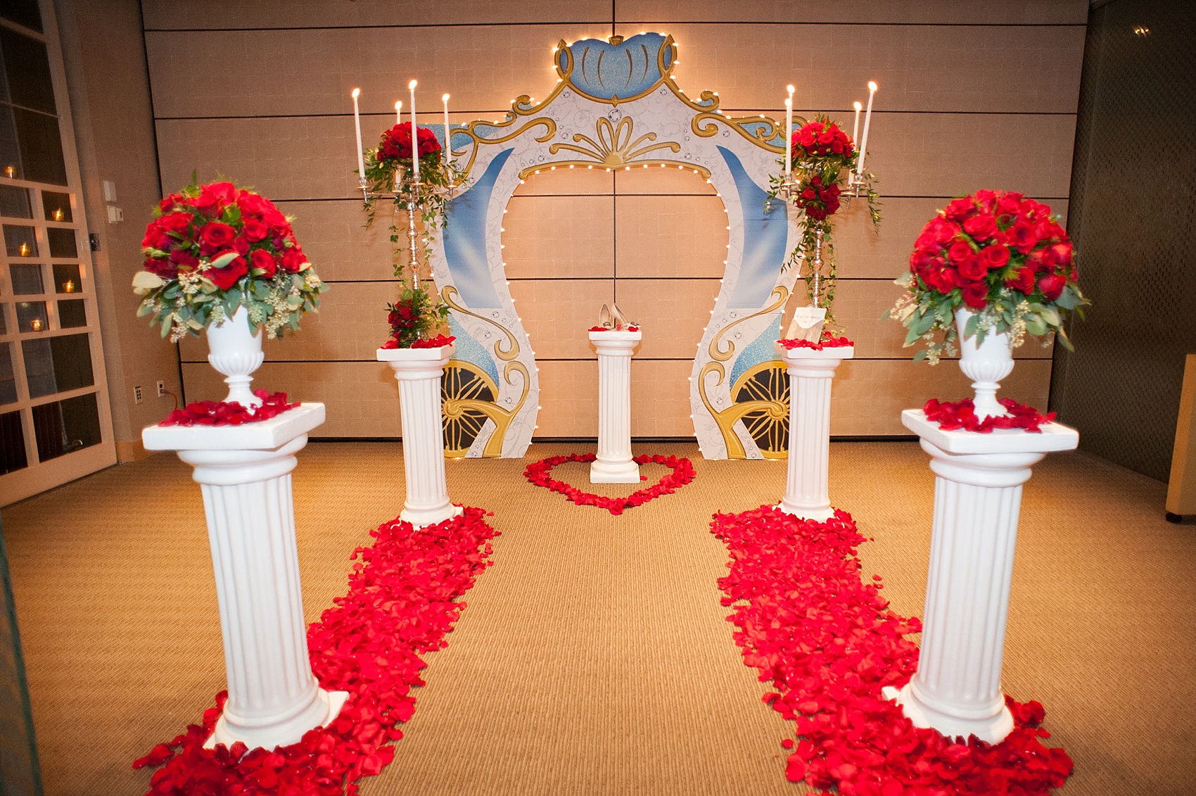 Red rose lined walkway for a Disney Cinderella proposal at Le Bernadin captured by Mikkel Paige, New York City wedding photographer. Coordination by Brilliant Event Planning.