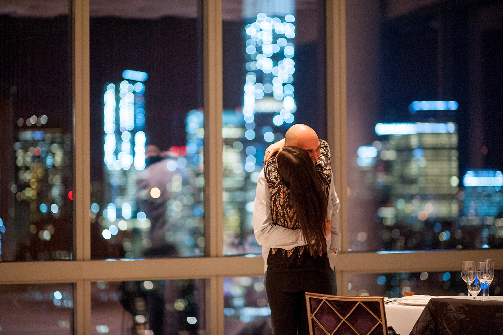 NYC Proposal Photos by Mikkel Paige Photography. Candlelight rose aisle at Trump Soho overlooking NYC skyline. 