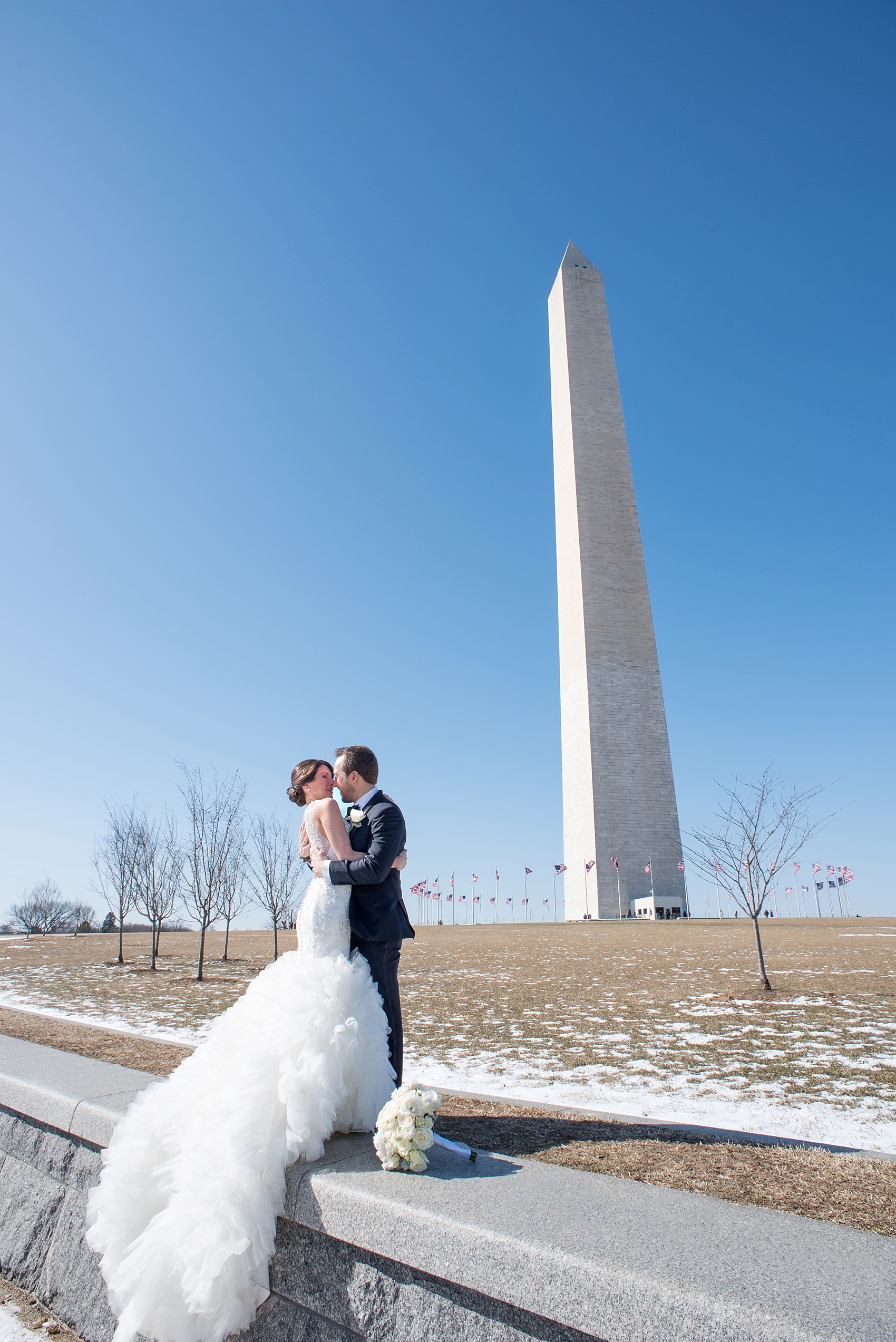 Washington, DC wedding photos by Mikkel Paige. The bride and groom take photos on the National Mall with the Washington Monument.
