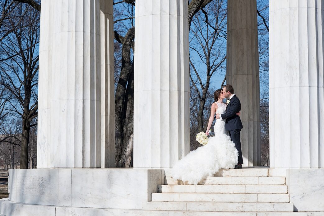 Washington, DC wedding photos by Mikkel Paige. The bride and groom take photos on the National Mall with the DC war memorial and stoic white columns.