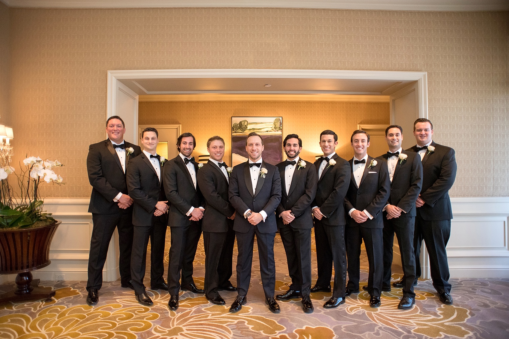 Washington, DC wedding photos by Mikkel Paige. The wedding party poses for a photo at The Ritz Carlton, Pentagon City.