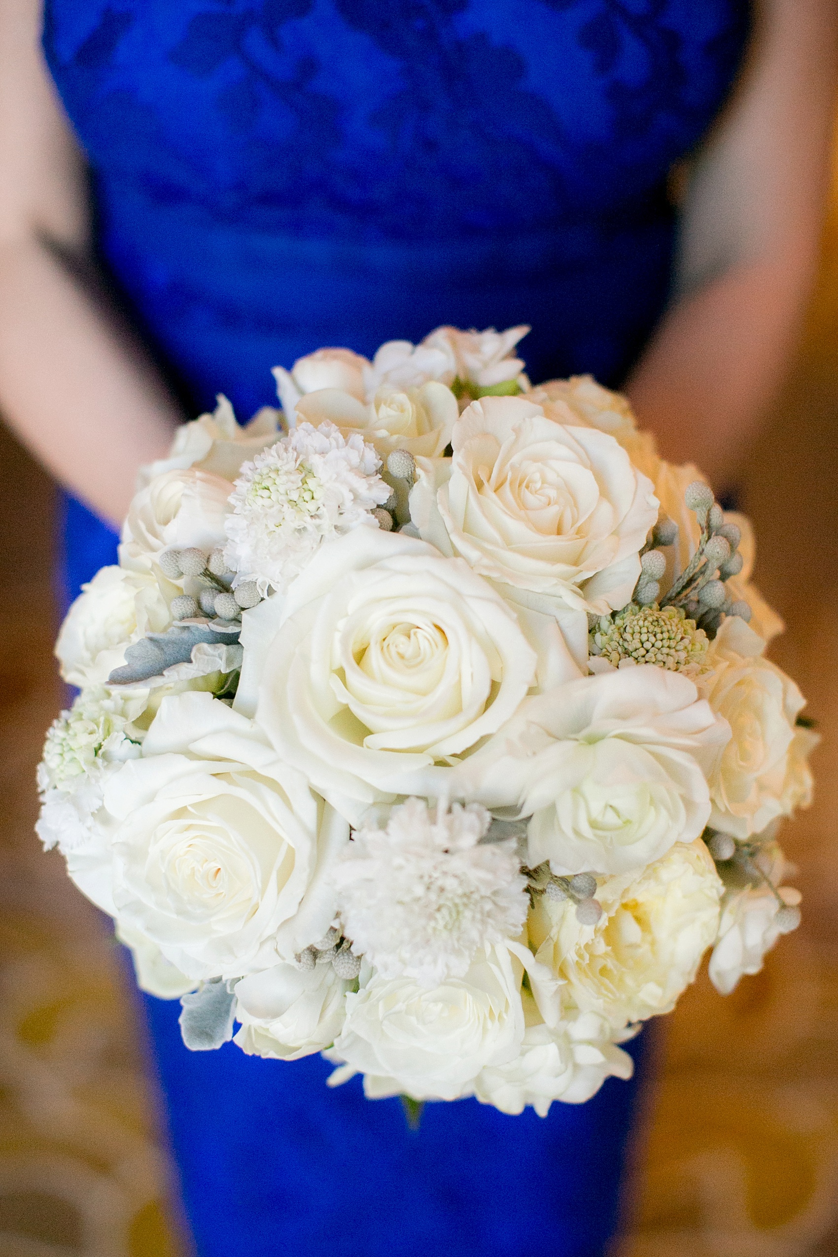 Washington, DC wedding photos by Mikkel Paige. The maid of honor in cobalt blue carried an all winter white bouquet at The Ritz Carlton, Pentagon City.