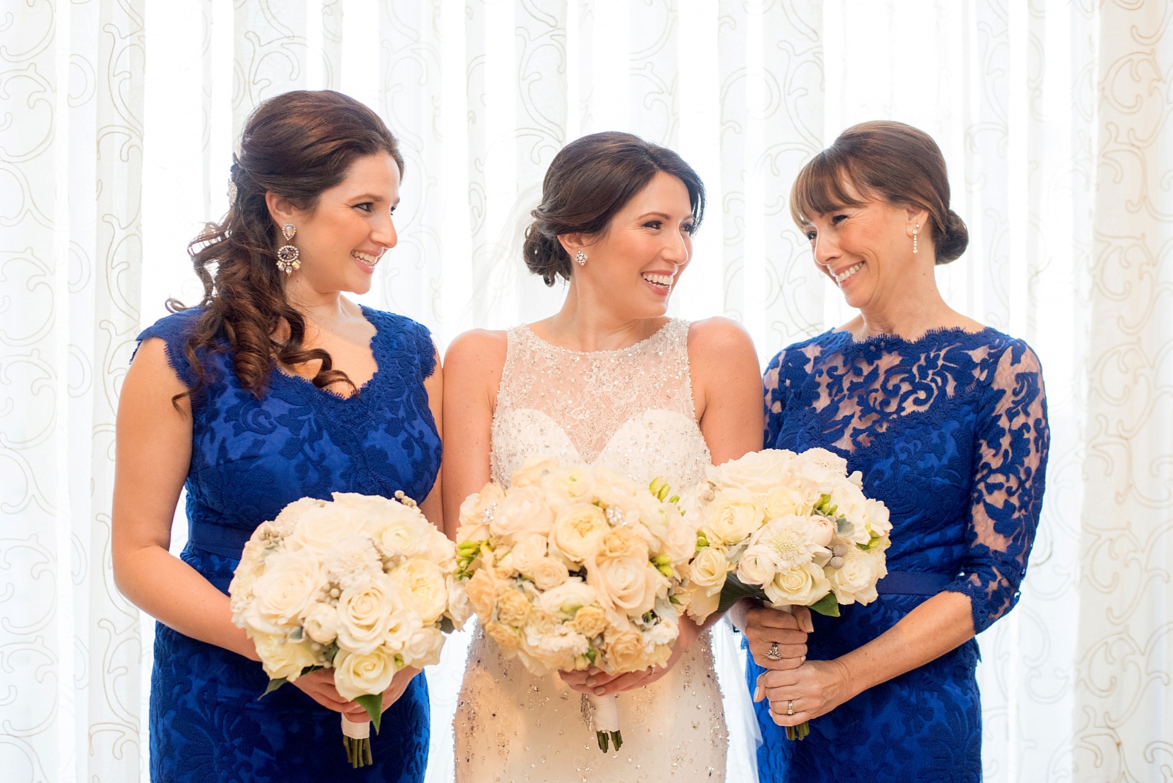 Washington, DC wedding photos by Mikkel Paige. The bride with her maid of honor in cobalt blue pose for a photo at The Ritz Carlton, Pentagon City.