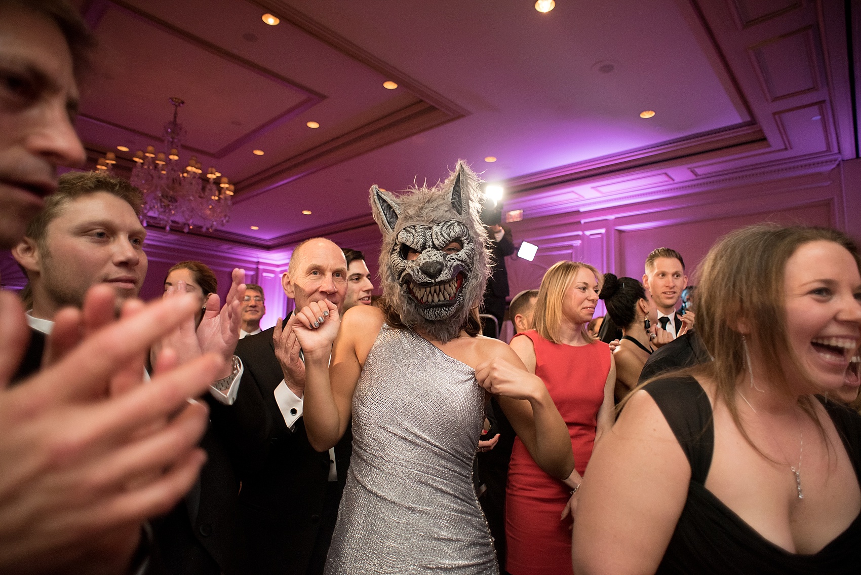 Washington, DC wedding photos by Mikkel Paige. A bridesmaids surprises the couple with a wolf mask the Ritz Carlton, Pentagon City.