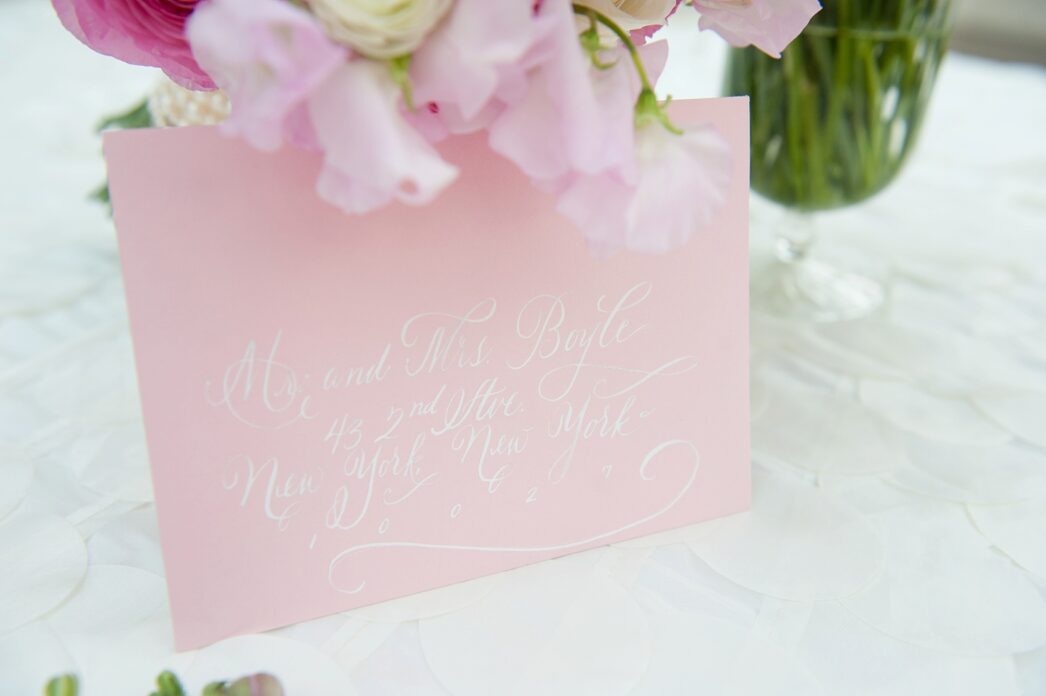 Pink and white wedding invitation envelope addressing options by Raleigh wedding photographer, Mikkel Paige. Calligraphy, digital printing and DIY options are discussed.