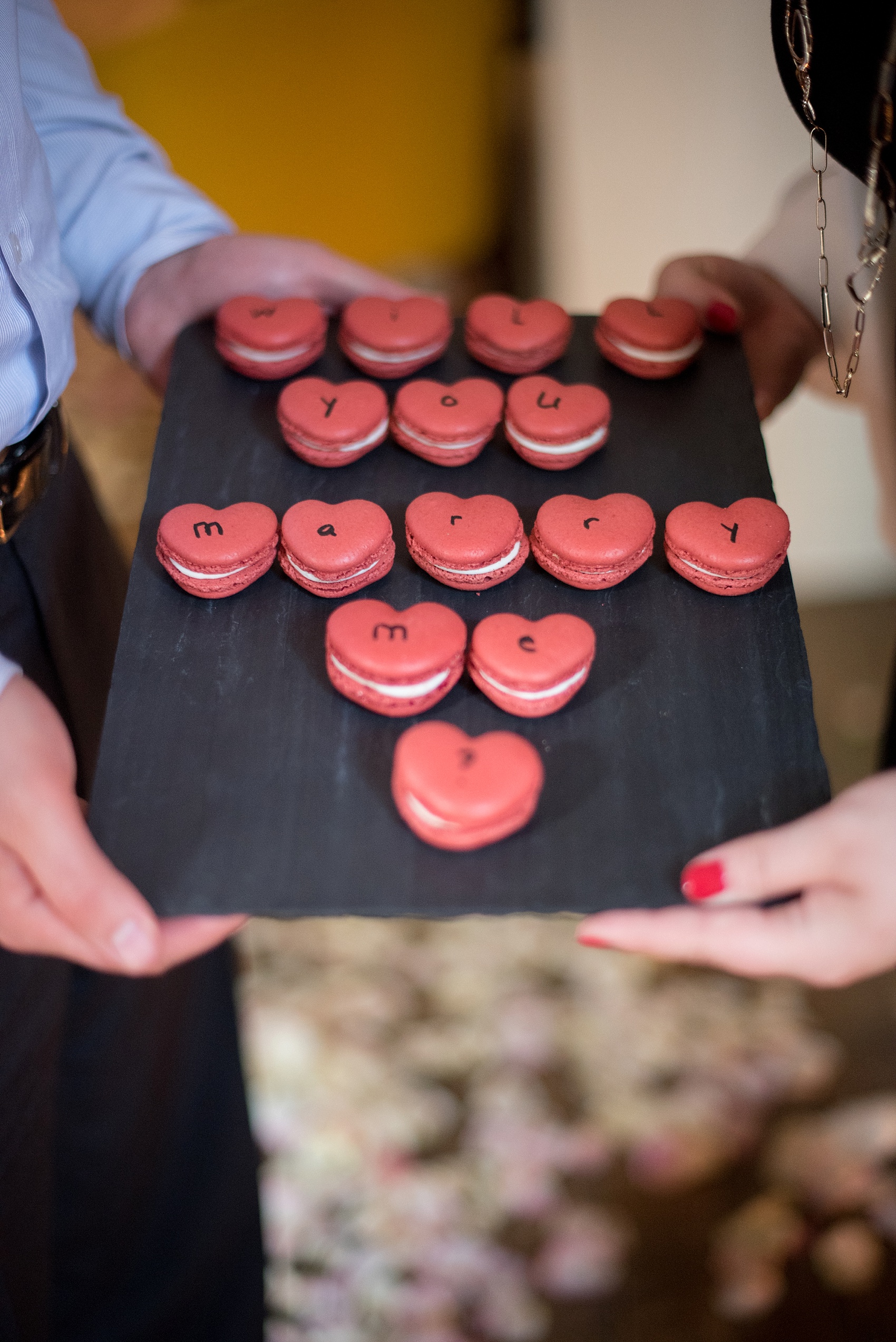 Red heart "Will You Marry Me?" macarons for a NYC Proposal in Chelsea, Haven's Kitchen. Photos by NYC wedding photographer Mikkel Paige.
