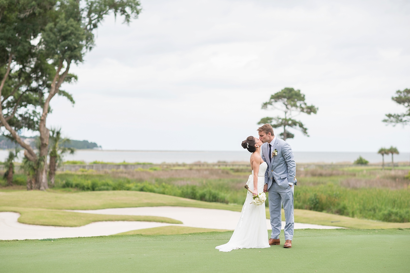 First look for the bride and groom on a golf course in Haig Point, South Carolina, off the coast of Hilton Head. Photos by Mikkel Paige Photography.