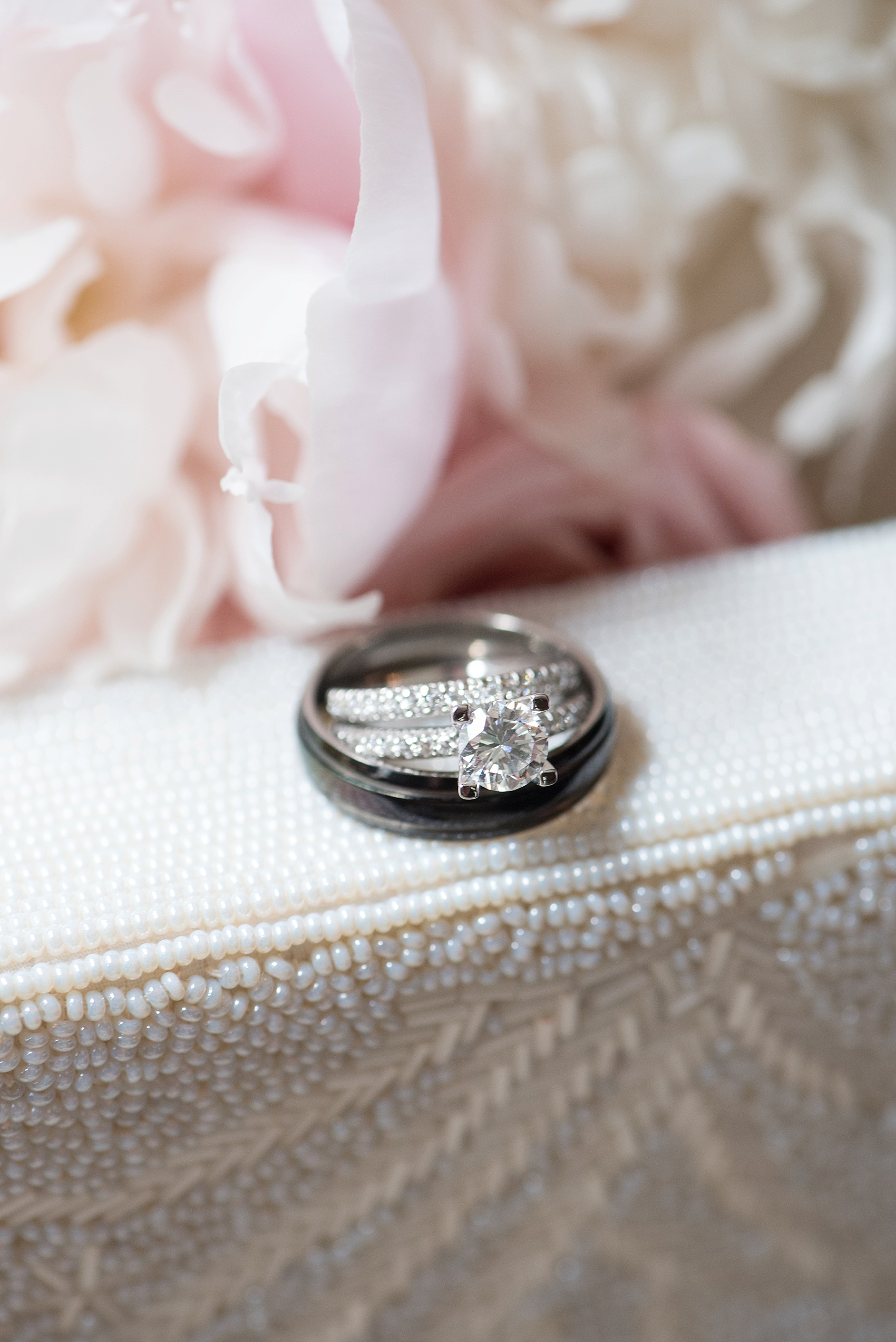Diamond round wedding ring and eternity band with black male ring for a Skylands Manor wedding. Image by Mikkel Paige Photography, NJ wedding photographer.