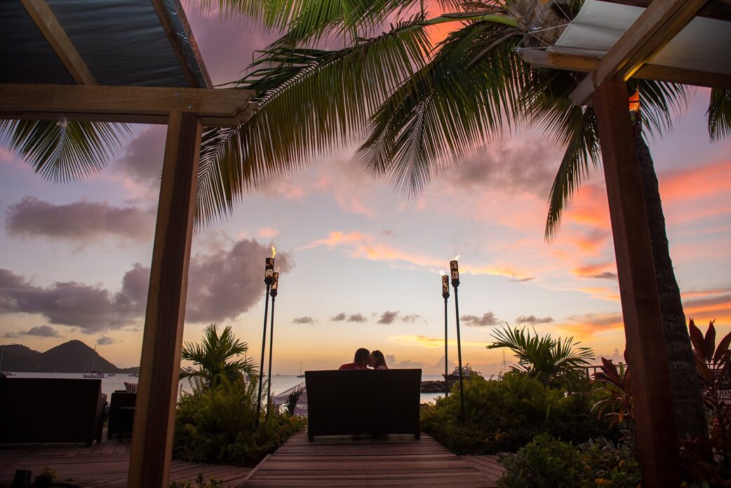 Sunset photo on St. Lucia Proposal ideas - beachside romance at an oceanfront dinner at The Landings resort. Images by destination wedding photographer Mikkel Paige Photography.