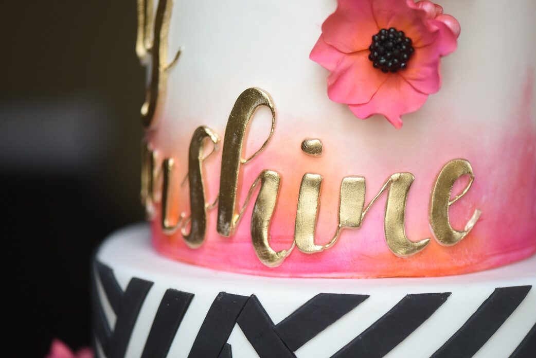 Modern pink and orange wedding ideas with black and white striped cake, gold lettering, and anemone gumpaste flowers. Photos by Mikkel Paige photography, planning by Ashton Events and Every Last Detail.
