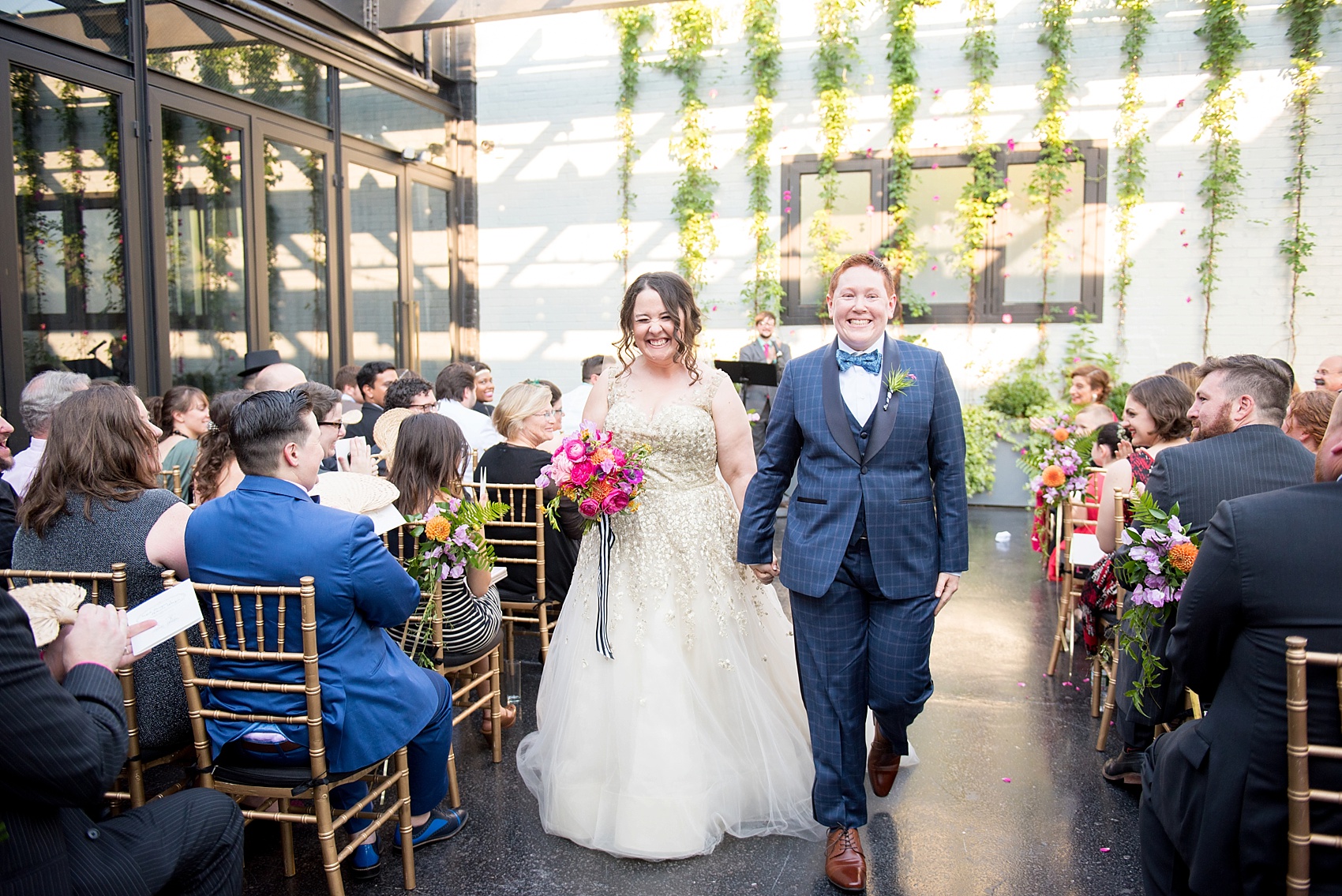 501 Union lesbian wedding ceremony with floral backdrop. Photos by Mikkel Paige Photography, in Brooklyn, NYC. Planning by Ashley M Chamblin Events.