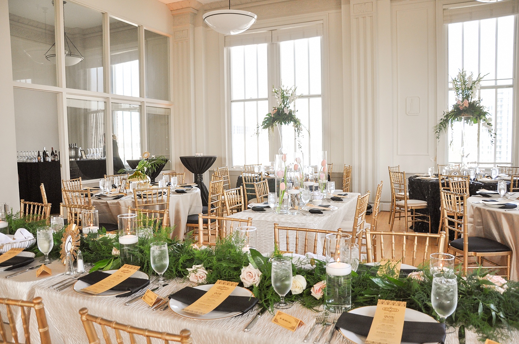 Downtown Raleigh Grand Ballroom wedding photos of Gatsby themed design with tropical leaves, white tulips, gold vase and black accents. Photos by Mikkel Paige Photography, flowers by Eclectic Sage.