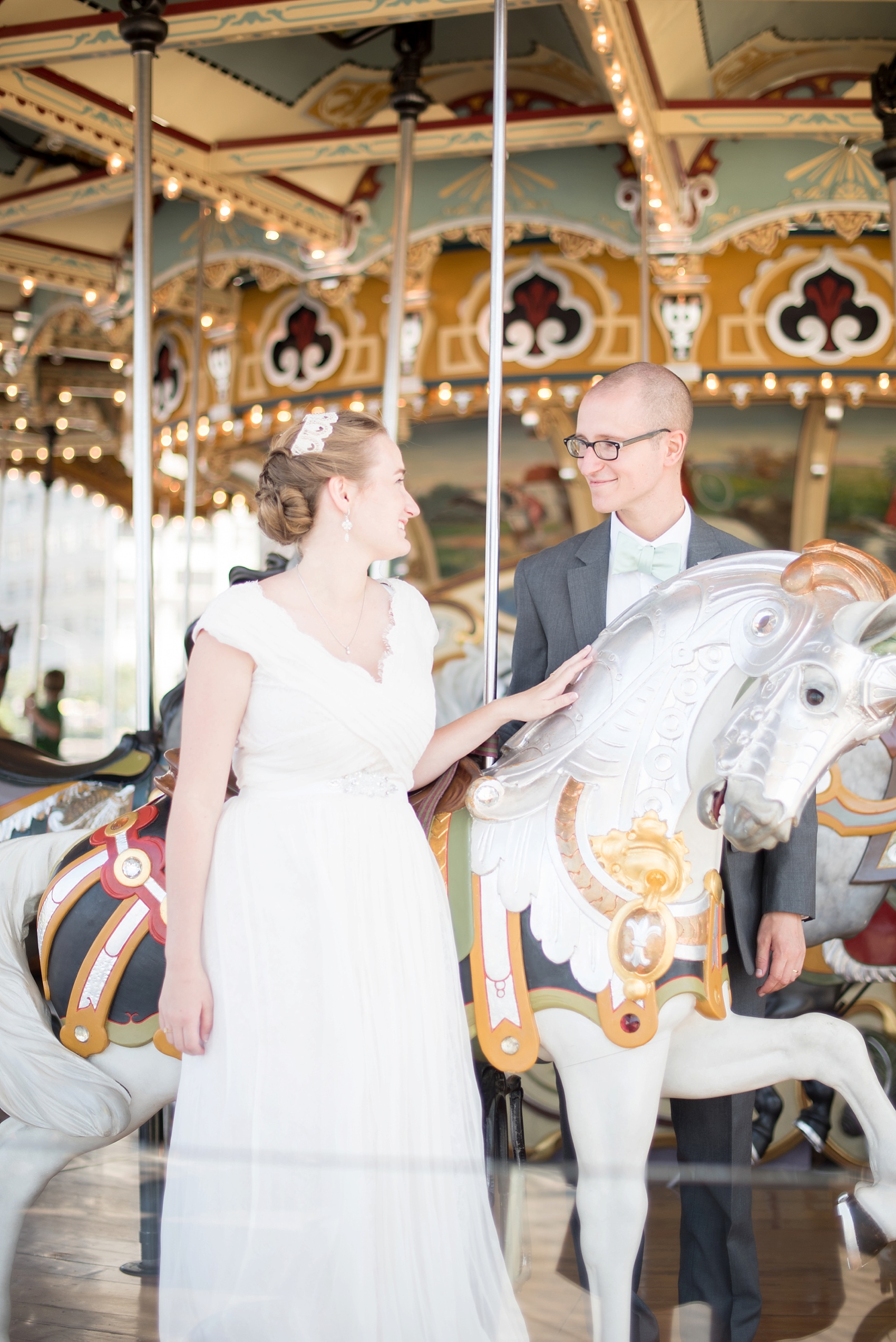Bride and groom photo in DUMBO, Brooklyn Bridge Park, Jane's Carousel. Photos by Mikkel Paige Photography, NYC wedding photographer.