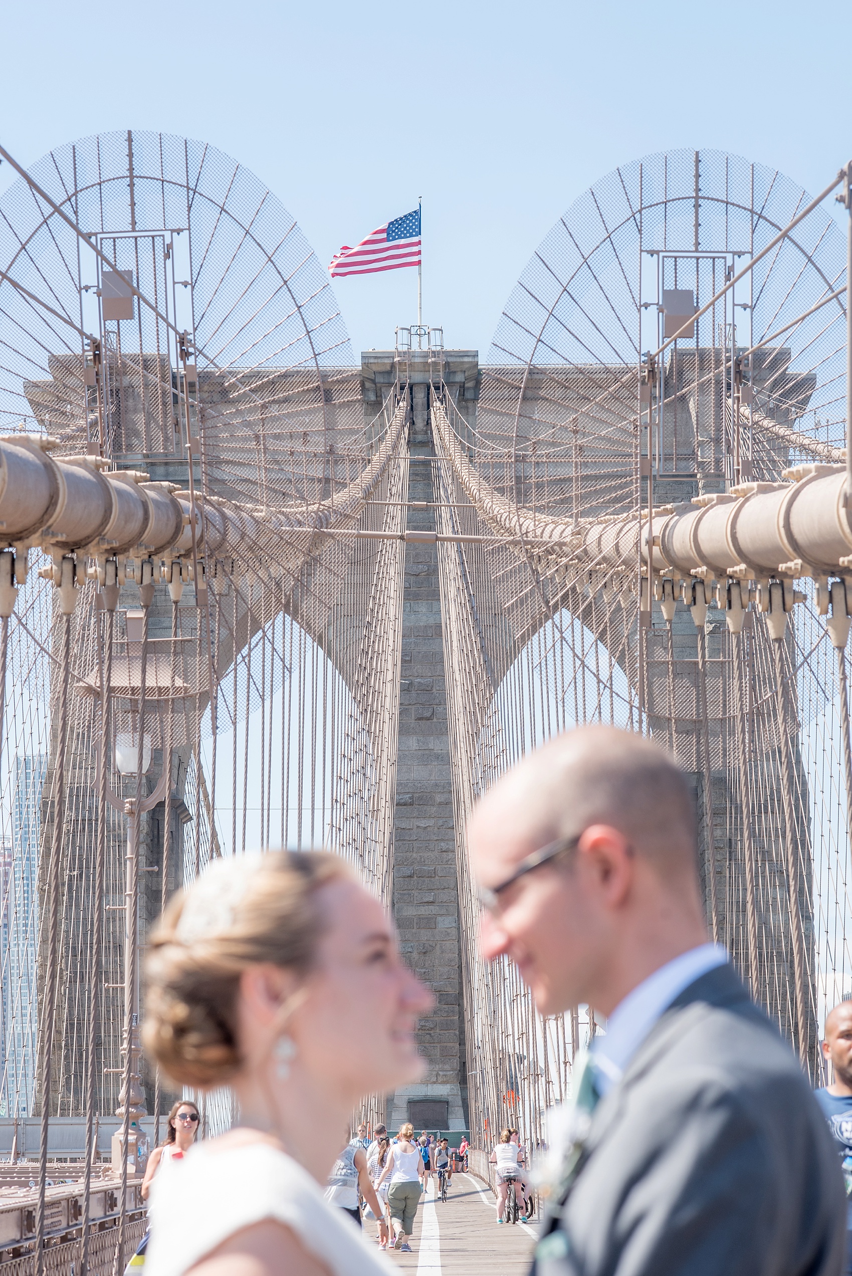 Bride and groom photo on the Brooklyn Bridge. Photos by Mikkel Paige Photography, NYC wedding photographer.