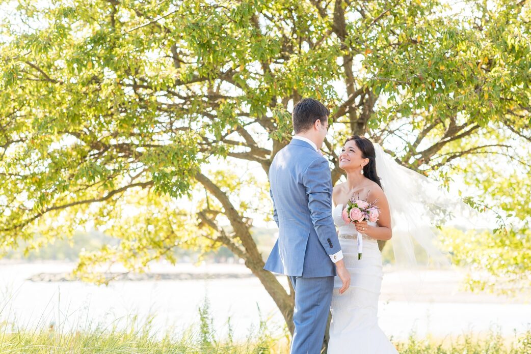 Connecticut beach wedding photos by Mikkel Paige Photography. Groom in blue suit and pink bow tie.