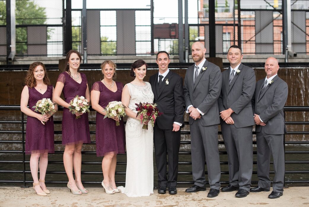 Wedding party photos in the rain! Burgundy bridesmaids with bride in beaded 1920s art deco gown. Bay 7 Durham, NC wedding. Photos by Mikkel Paige Photography.