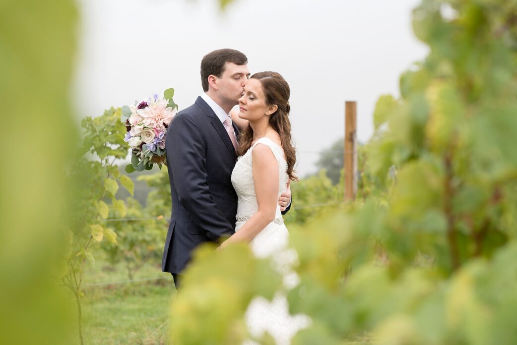 Red Maple Vineyard wedding. Photos by Mikkel Paige Photography. Bride and groom in the vines of the property after their first look.