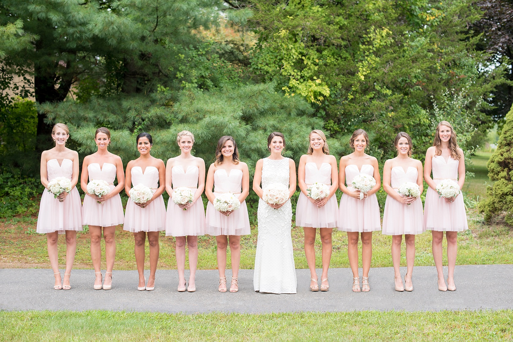 Bride with her bridesmaids in short pink dresses. By NYC wedding photographer Mikkel Paige Photography.