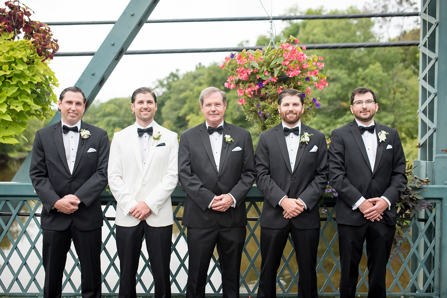 Groomsmen in Simsbury, Connecticut flower bridge. Images by NYC wedding photographer Mikkel Paige Photography.