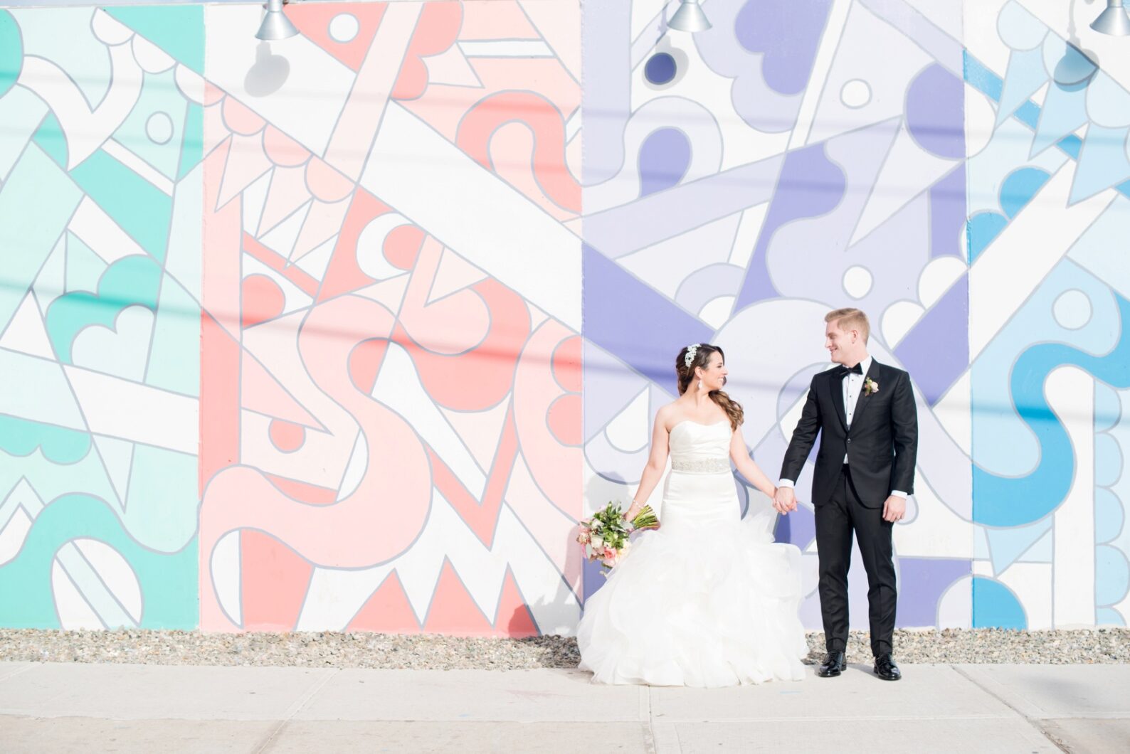 Coney Island colorful mural graffiti wedding photos by Mikkel Paige Photography, NYC wedding photographer. Planning by Dulce Dreams Events, flowers by Sachi Rose.