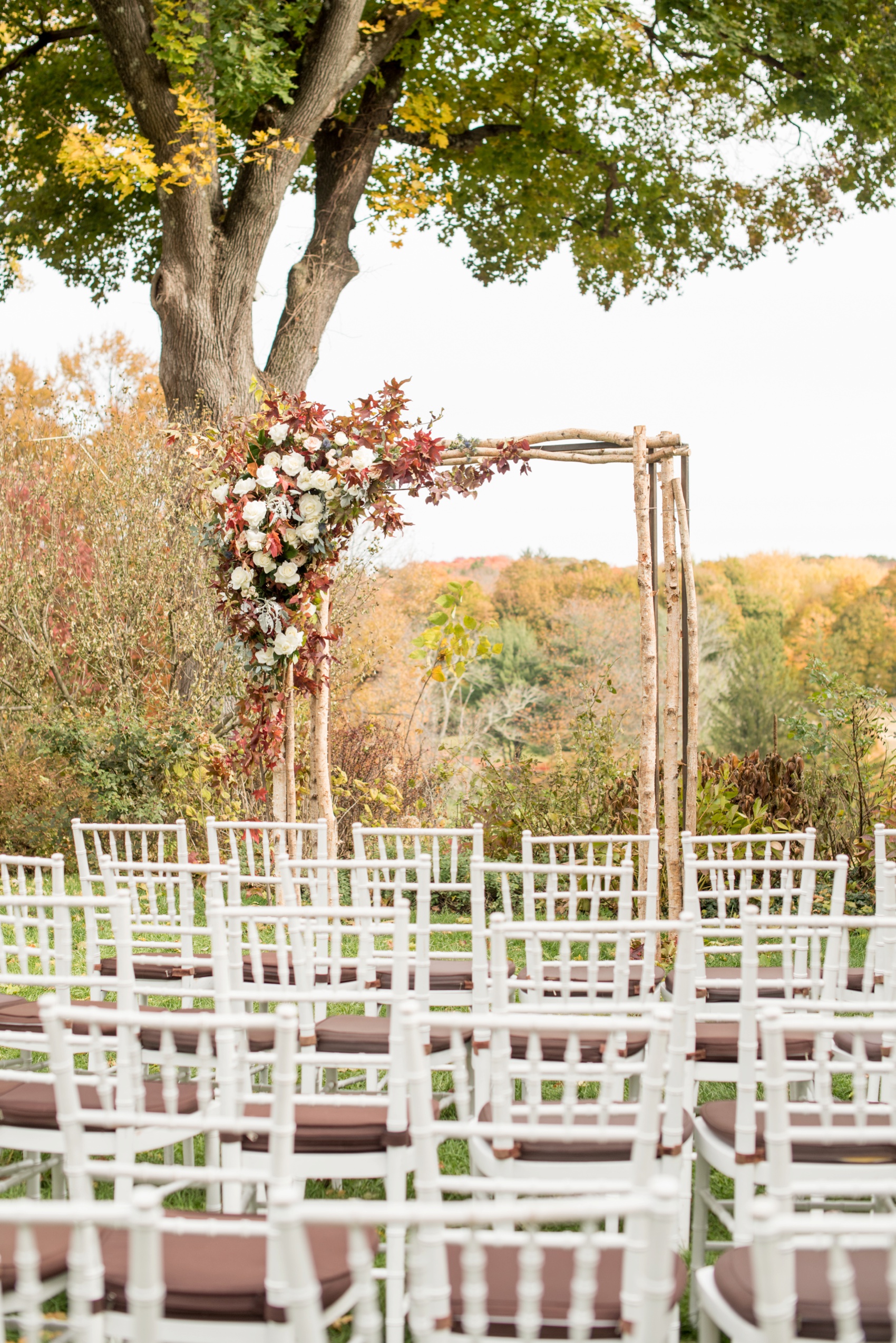Crabtree Kittle's House wedding in NY. Images by NYC wedding photographer Mikkel Paige Photography for a gay fall wedding. Fall leaves ceremony arch with birch branches by Mimosa Floral Design.