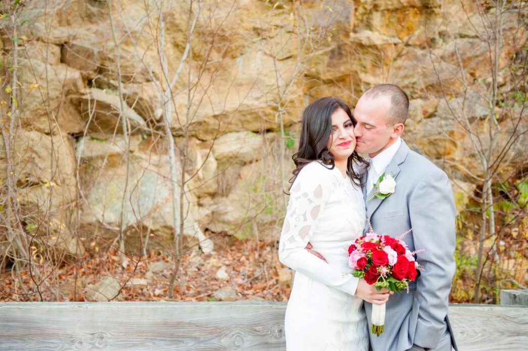 Intimate NJ church ceremony with images by Mikkel Paige Photography. Temperley London white long sleeve short wedding dress and red and pink rose bouquet.