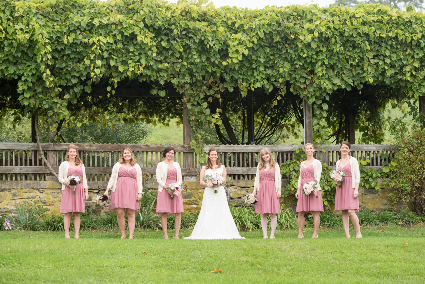 A Red Maple Vineyard wedding with dusty rose short dress bridesmaids. Photo by NYC wedding photographer Mikkel Paige Photography.
