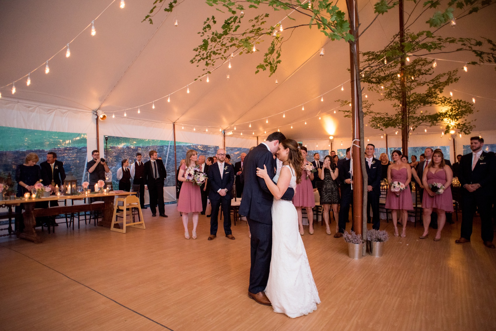 A Red Maple Vineyard wedding reception with trees under a tent and pink dusty rose accents. Photo by NYC wedding photographer Mikkel Paige Photography.