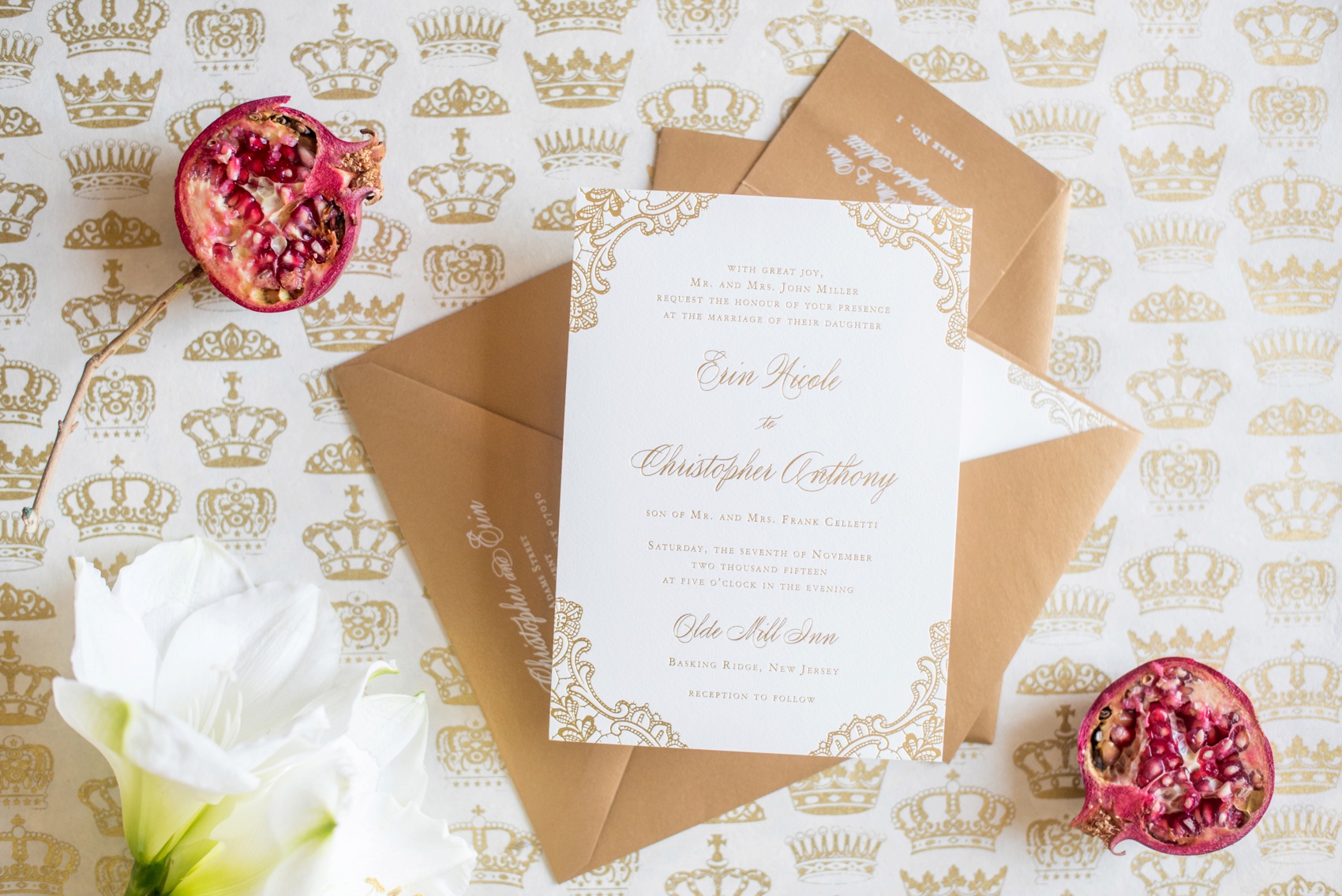 Gold and white invitation photo with pomegranate by Mikkel Paige Photography, NYC and Raleigh wedding photographer.